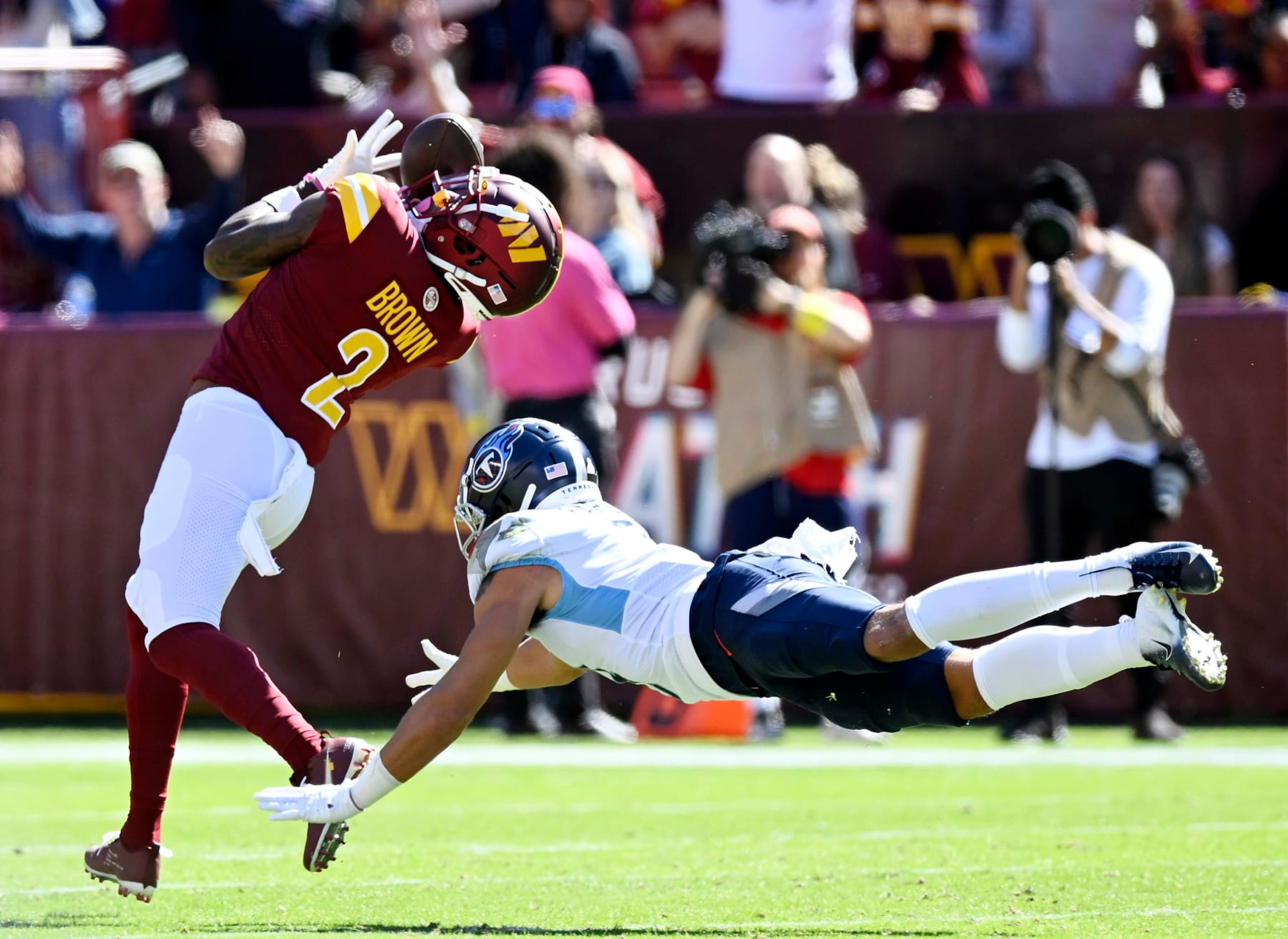 LANDOVER, MARYLAND - OCTOBER 09: Dyami Brown #2 of the Washington Commanders catches a touchdown pass over Caleb Farley #3 of the Tennessee Titans during the second quarter at FedExField on October 09, 2022 in Landover, Maryland. (Photo by Greg Fiume/Getty Images)