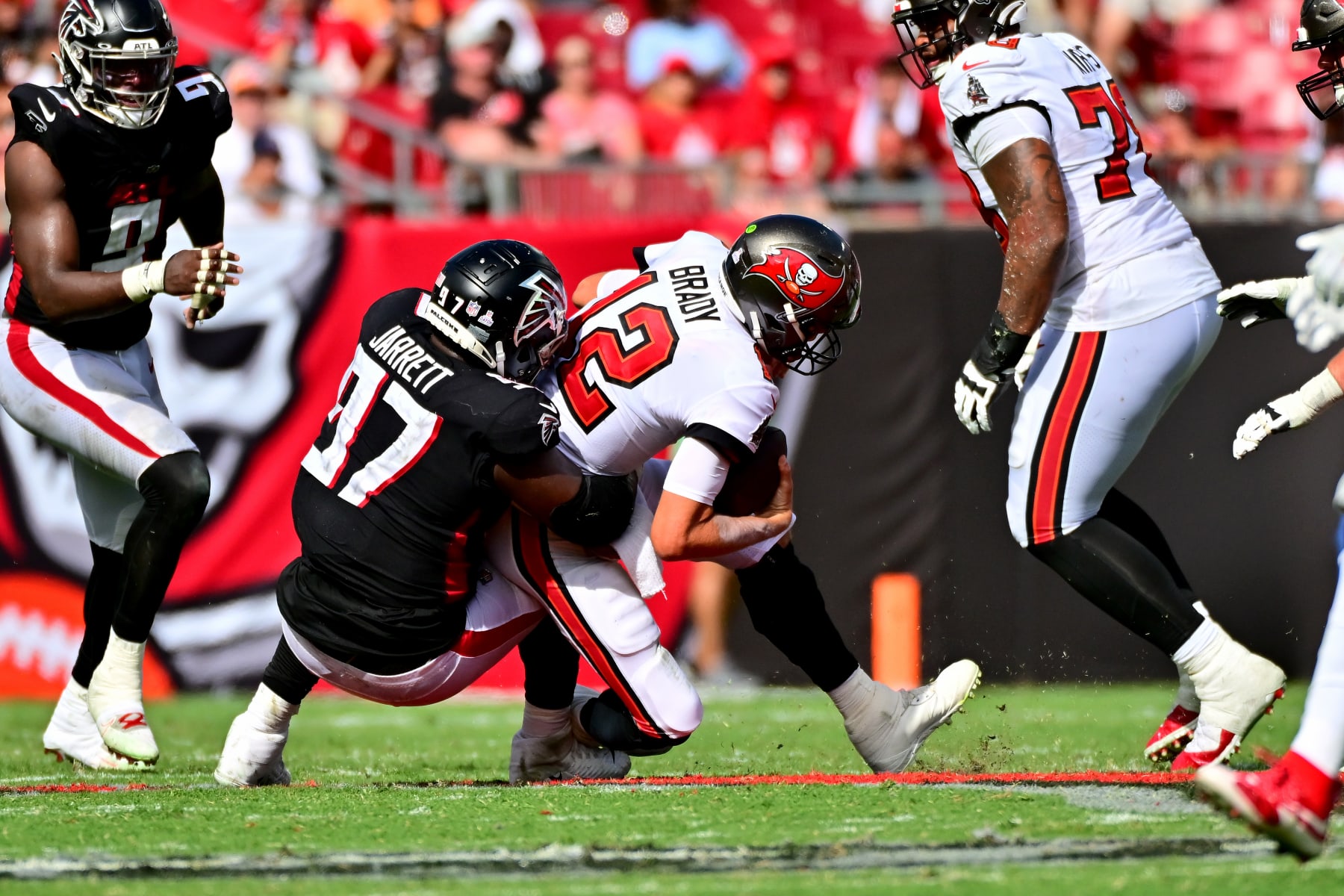 TAMPA, FLORIDA - OCTOBER 09: Grady Jarrett #97 of the Atlanta Falcons sacks Tom Brady #12 of the Tampa Bay Buccaneers during the fourth quarter of the game at Raymond James Stadium on October 09, 2022 in Tampa, Florida. (Photo by Julio Aguilar/Getty Images)