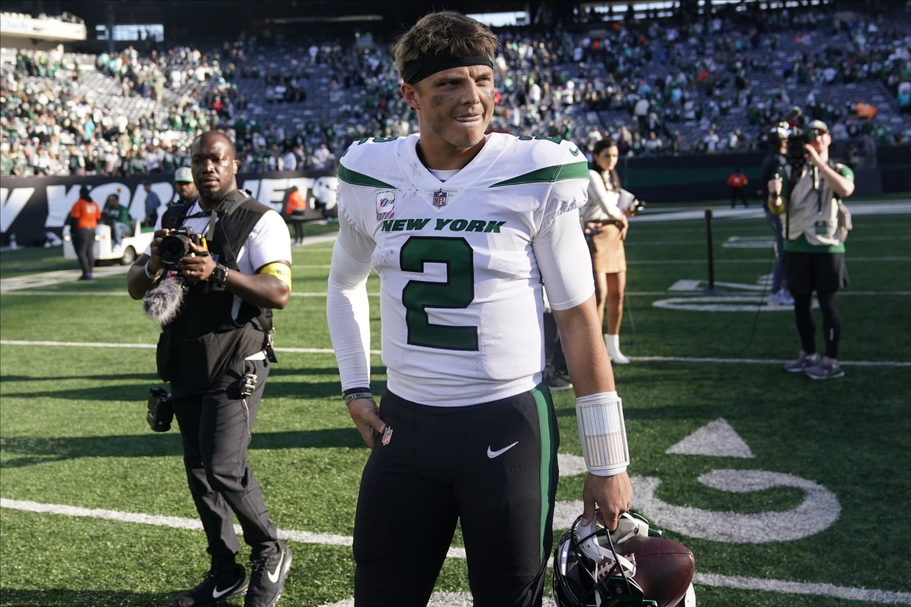 New York Jets quarterback Zach Wilson (2) walks off the field after defeating the Miami Dolphins in an NFL football game, Sunday, Oct. 9, 2022, in East Rutherford, N.J. (AP Photo/Seth Wenig)