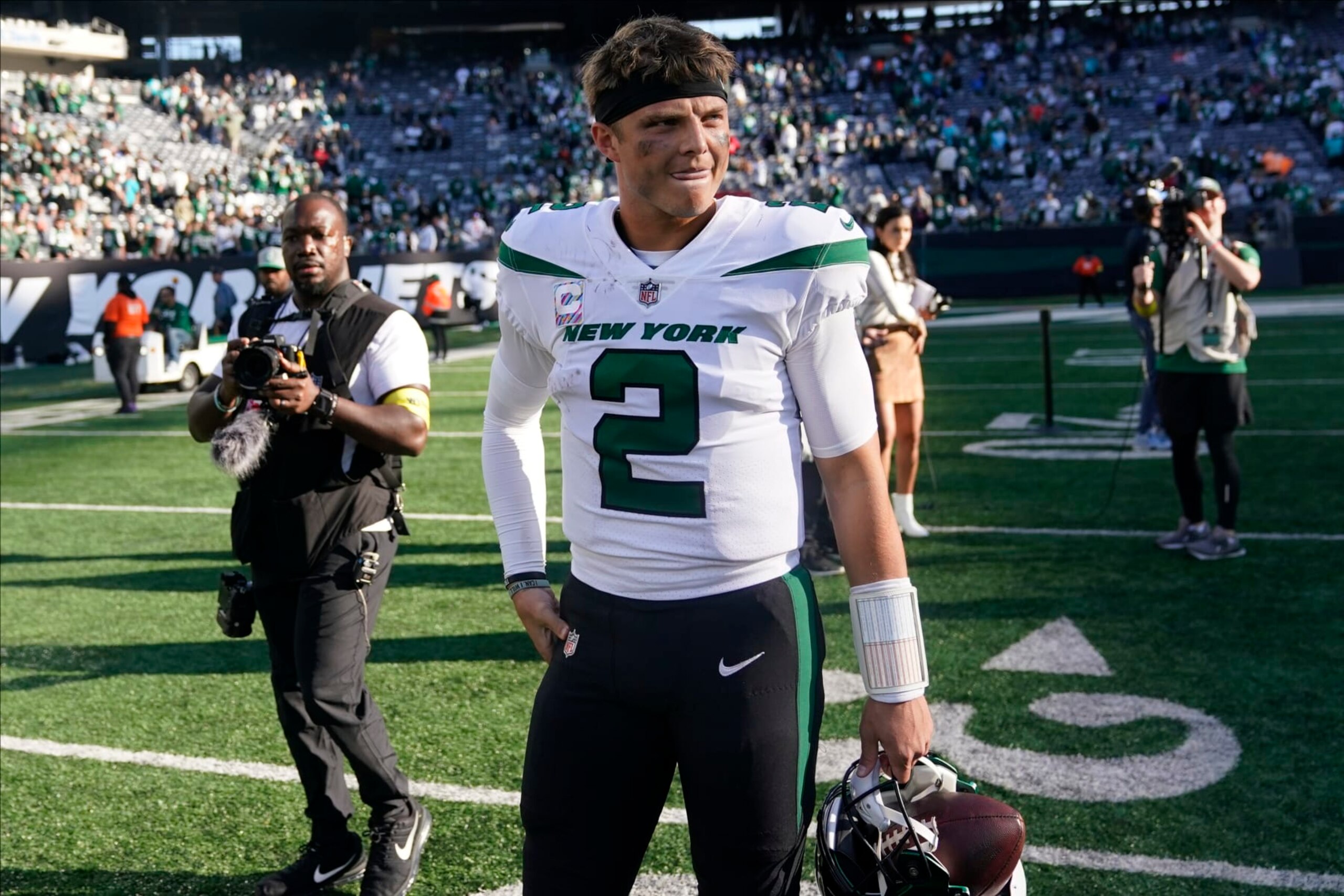 New York Jets quarterback Zach Wilson (2) walks off the field after defeating the Miami Dolphins in an NFL football game, Sunday, Oct. 9, 2022, in East Rutherford, N.J. (AP Photo/Seth Wenig)