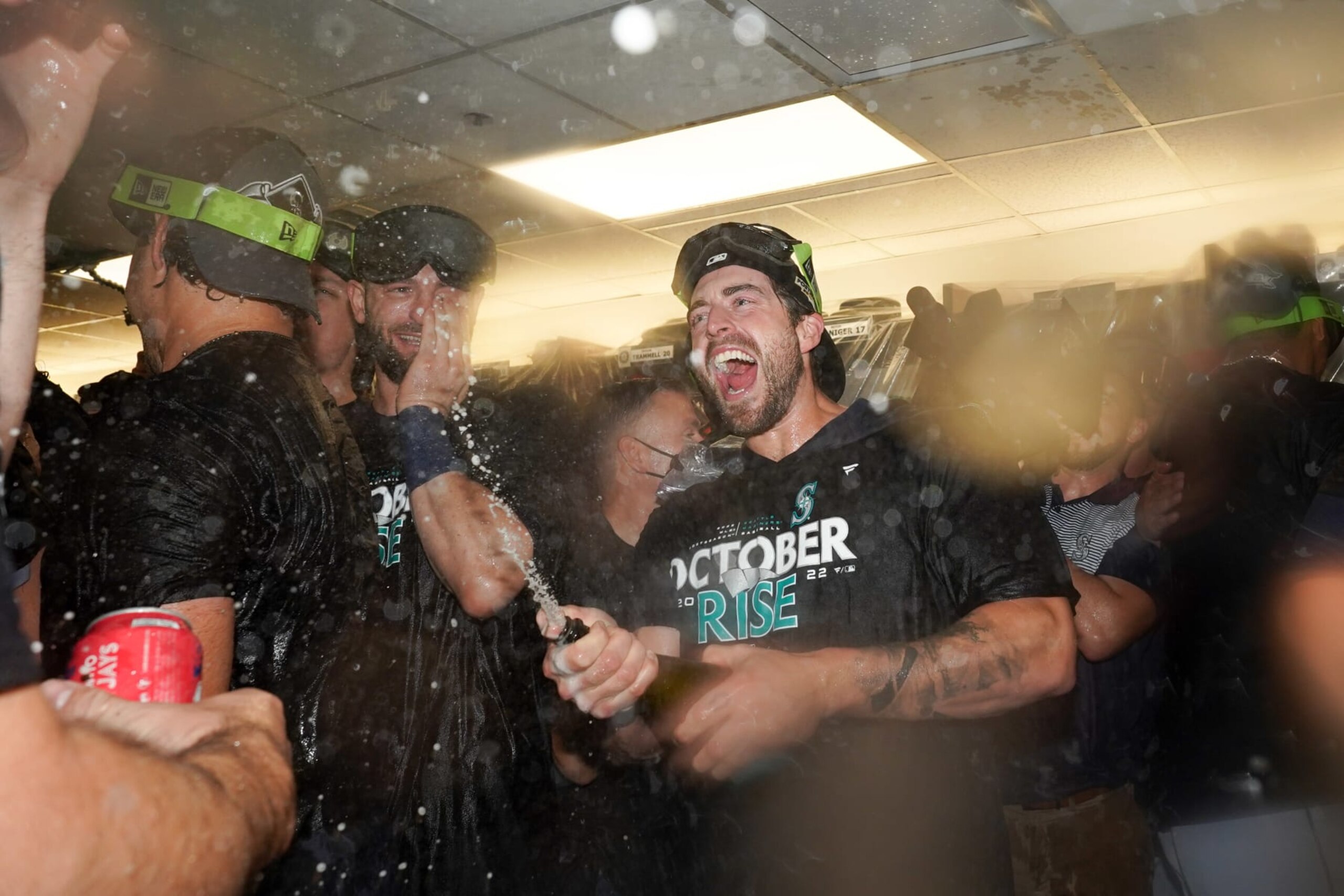 TORONTO,  - OCTOBER 08:   Members of the Seattle Mariners celebrate in the locker room while celebrating after the teams Wild Card game two win over the Toronto Blue Jays at Rogers Centre on Saturday, October 8, 2022 in Toronto, Canada. (Photo by Thomas Skrlj/MLB Photos via Getty Images)