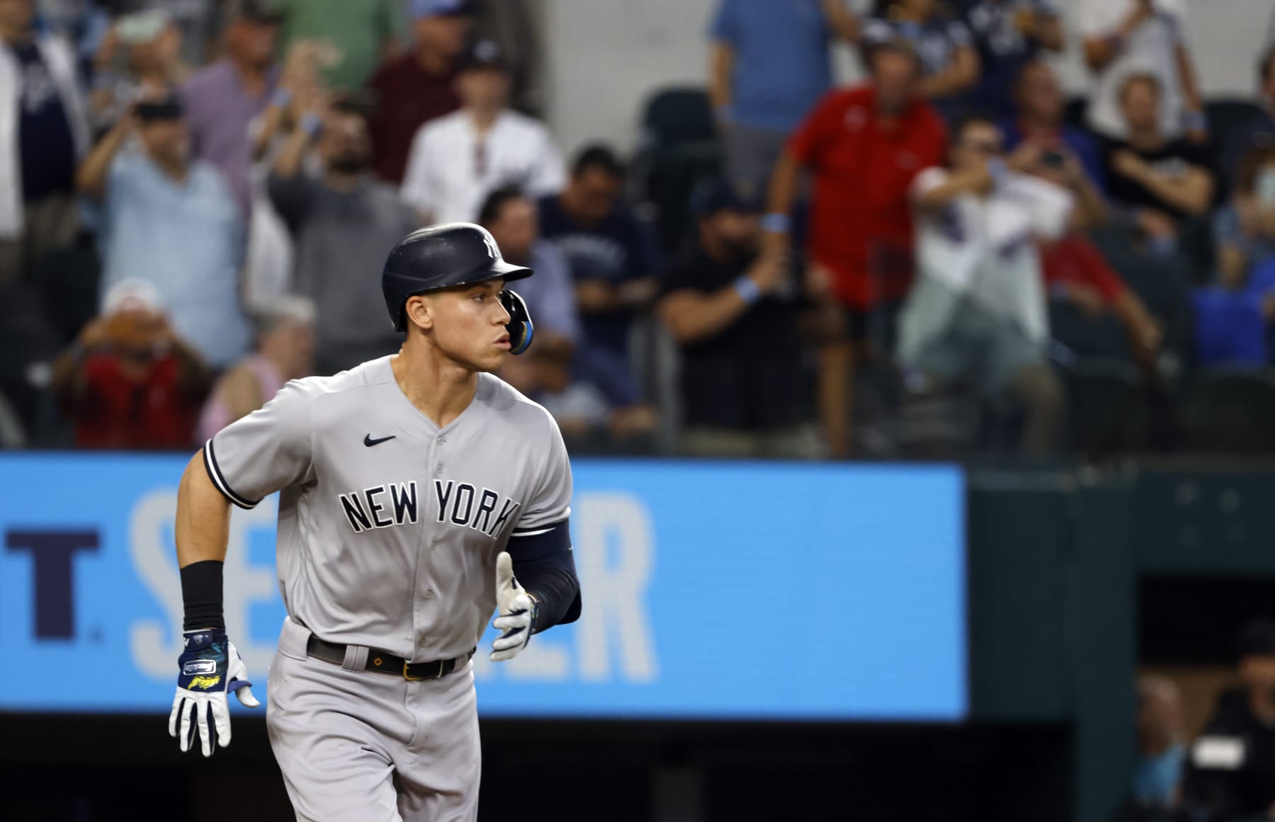 ARLINGTON, TX - OCTOBER 4: Aaron Judge #99 of the New York Yankees runs to first base against the Texas Rangers in game one of a double header at Globe Life Field on October 4, 2022 in Arlington, Texas. (Photo by Ron Jenkins/Getty Images)