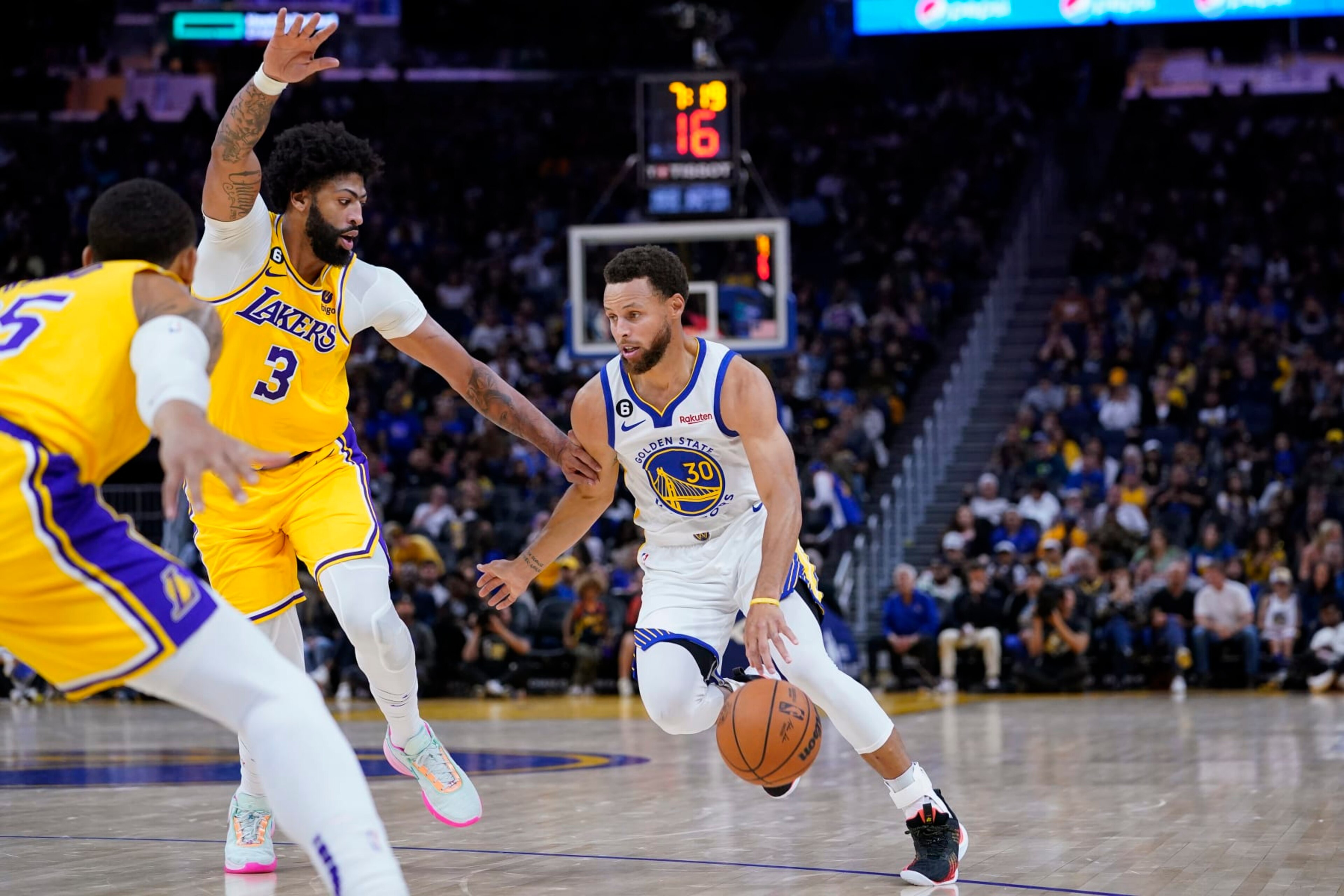 Golden State Warriors guard Stephen Curry (30) dribbles toward the basket while defended by Los Angeles Lakers forward Anthony Davis (3) during the first half of a basketball game in San Francisco, Sunday, Oct. 9, 2022. (AP Photo/Godofredo A. V·squez) Golden State Warriors guard Stephen Curry (30) dribbles toward the basket while defended by Los Angeles Lakers forward Anthony Davis (3) during the first half of a basketball game in San Francisco, Sunday, Oct. 9, 2022. (AP Photo/Godofredo A. V·squez)