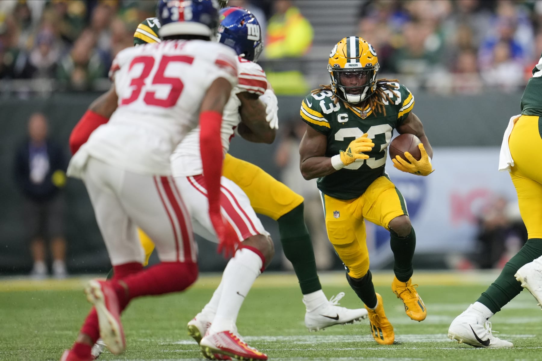 Green Bay Packers running back Aaron Jones (33) carries the ball during the second half of an NFL football game against the New York Giants at the Tottenham Hotspur stadium in London, Sunday, Oct. 9, 2022. (AP Photo/Kin Cheung)