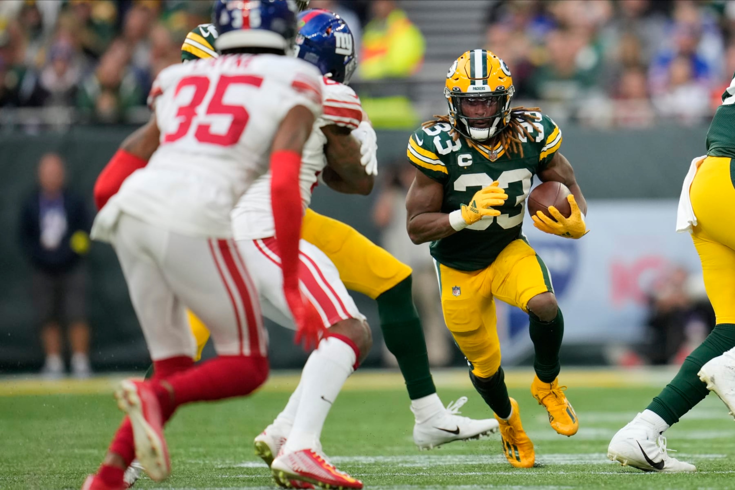 Green Bay Packers running back Aaron Jones (33) carries the ball during the second half of an NFL football game against the New York Giants at the Tottenham Hotspur stadium in London, Sunday, Oct. 9, 2022. (AP Photo/Kin Cheung)