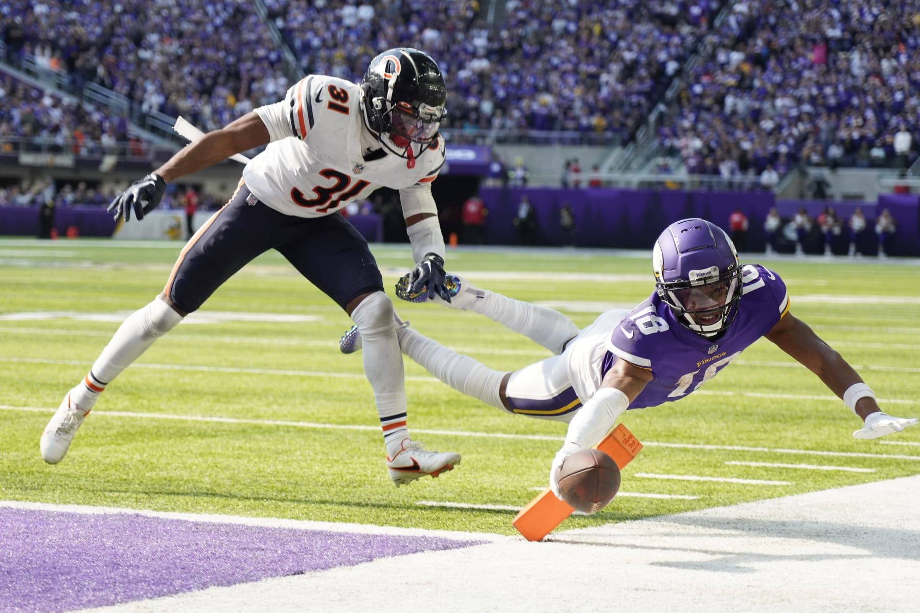 MINNEAPOLIS, MINNESOTA - OCTOBER 09: Justin Jefferson #18 of the Minnesota Vikings dives for a conversion against Jaylon Jones #31 of the Chicago Bears during the fourth quarter at U.S. Bank Stadium on October 09, 2022 in Minneapolis, Minnesota. (Photo by David Berding/Getty Images)