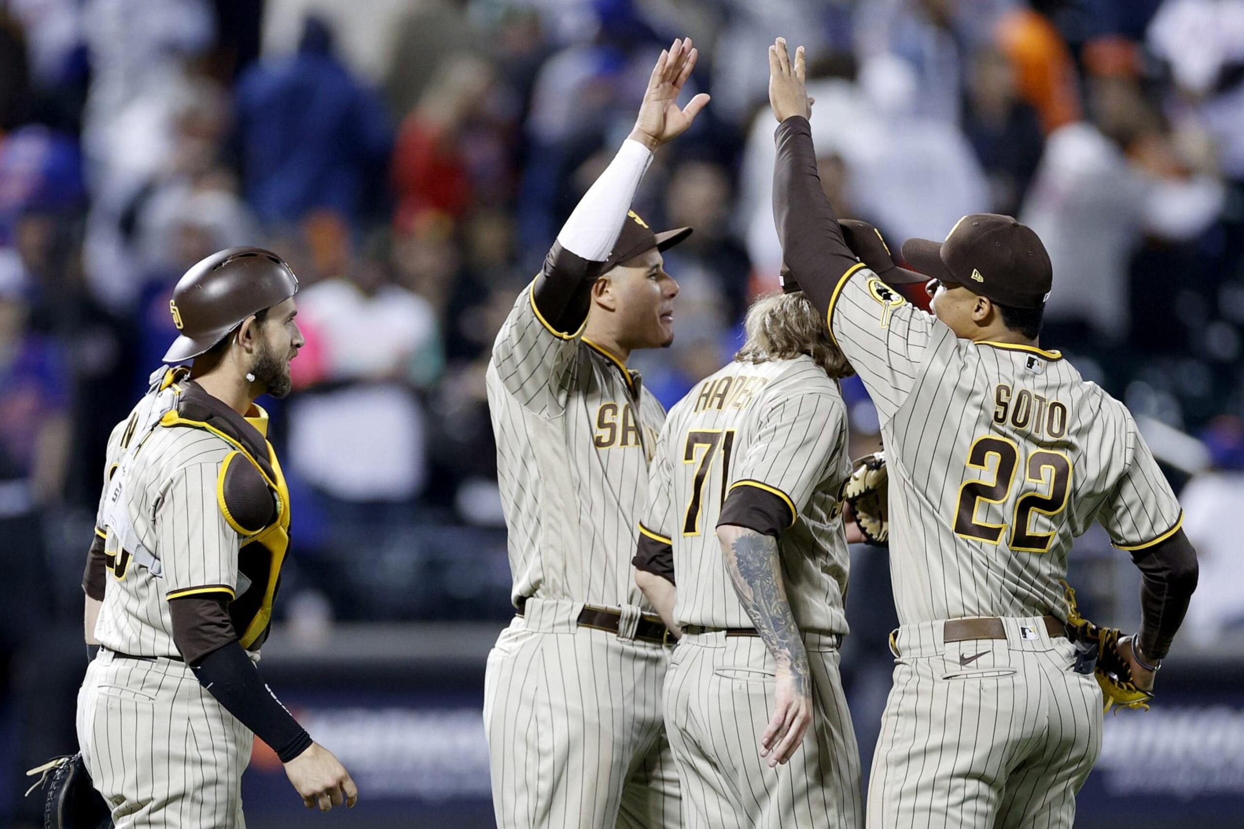 NEW YORK, NEW YORK - OCTOBER 09: Josh Hader #71 of the San Diego Padres celebrates with Austin Nola #26, Juan Soto #22 and Manny Machado #13 after defeating the New York Mets in game three to win the National League Wild Card Series at Citi Field on October 09, 2022 in the Flushing neighborhood of the Queens borough of New York City. The San Diego Padres defeated the New York Mets with a score of 6 to 0. (Photo by Sarah Stier/Getty Images)