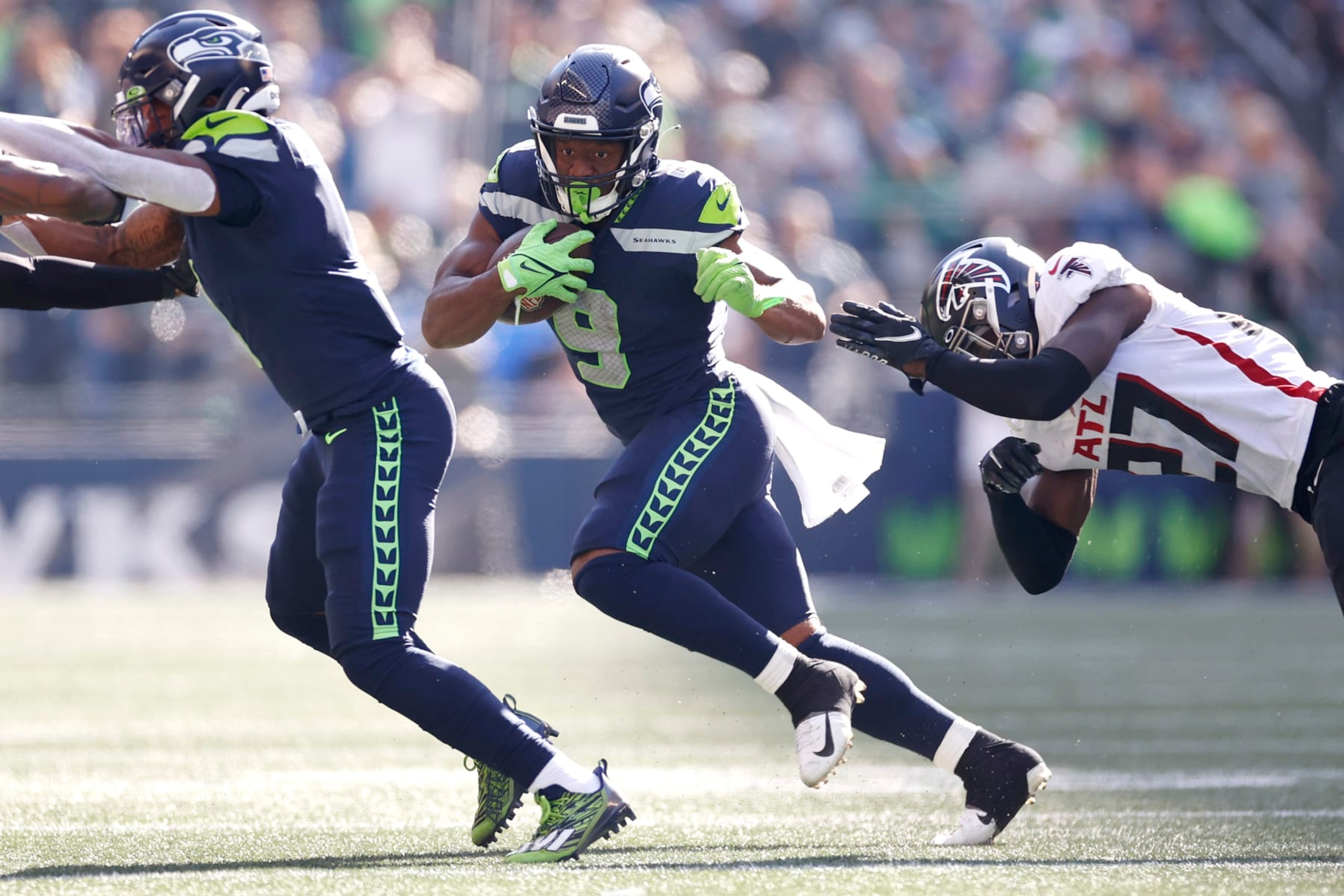 SEATTLE, WASHINGTON - SEPTEMBER 25: Kenneth Walker III #9 of the Seattle Seahawks runs with the ball against Richie Grant #27 of the Atlanta Falcons during the third quarter at Lumen Field on September 25, 2022 in Seattle, Washington. (Photo by Steph Chambers/Getty Images)