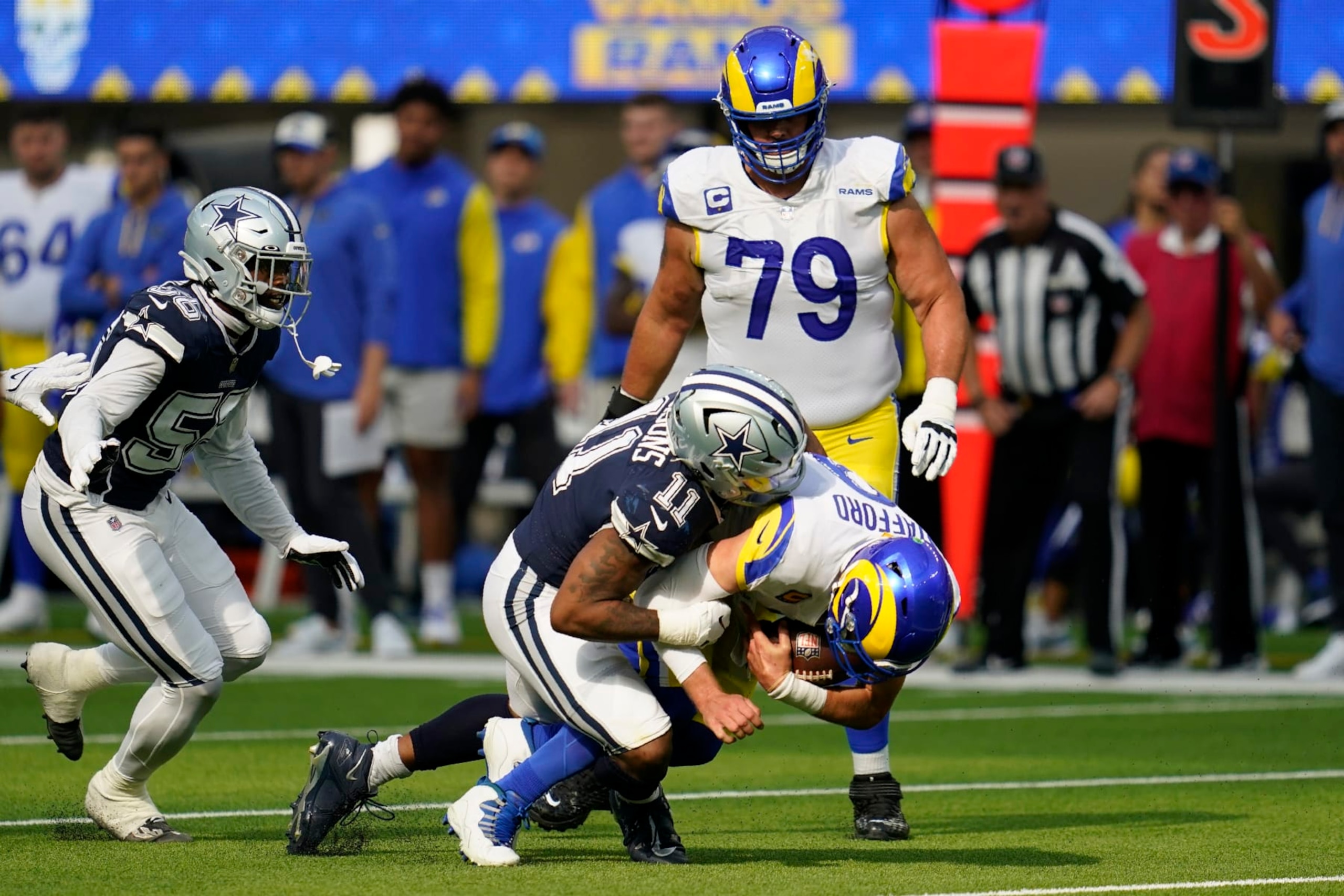 Dallas Cowboys linebacker Micah Parsons (11) sacks Los Angeles Rams quarterback Matthew Stafford (9) and defensive end Dante Fowler Jr. (56) and Rams offensive tackle Rob Havenstein (79) look on in the second half of an NFL football game, Sunday, Oct. 9, 2022, in Inglewood, Calif. (AP Photo/Ashley Landis)