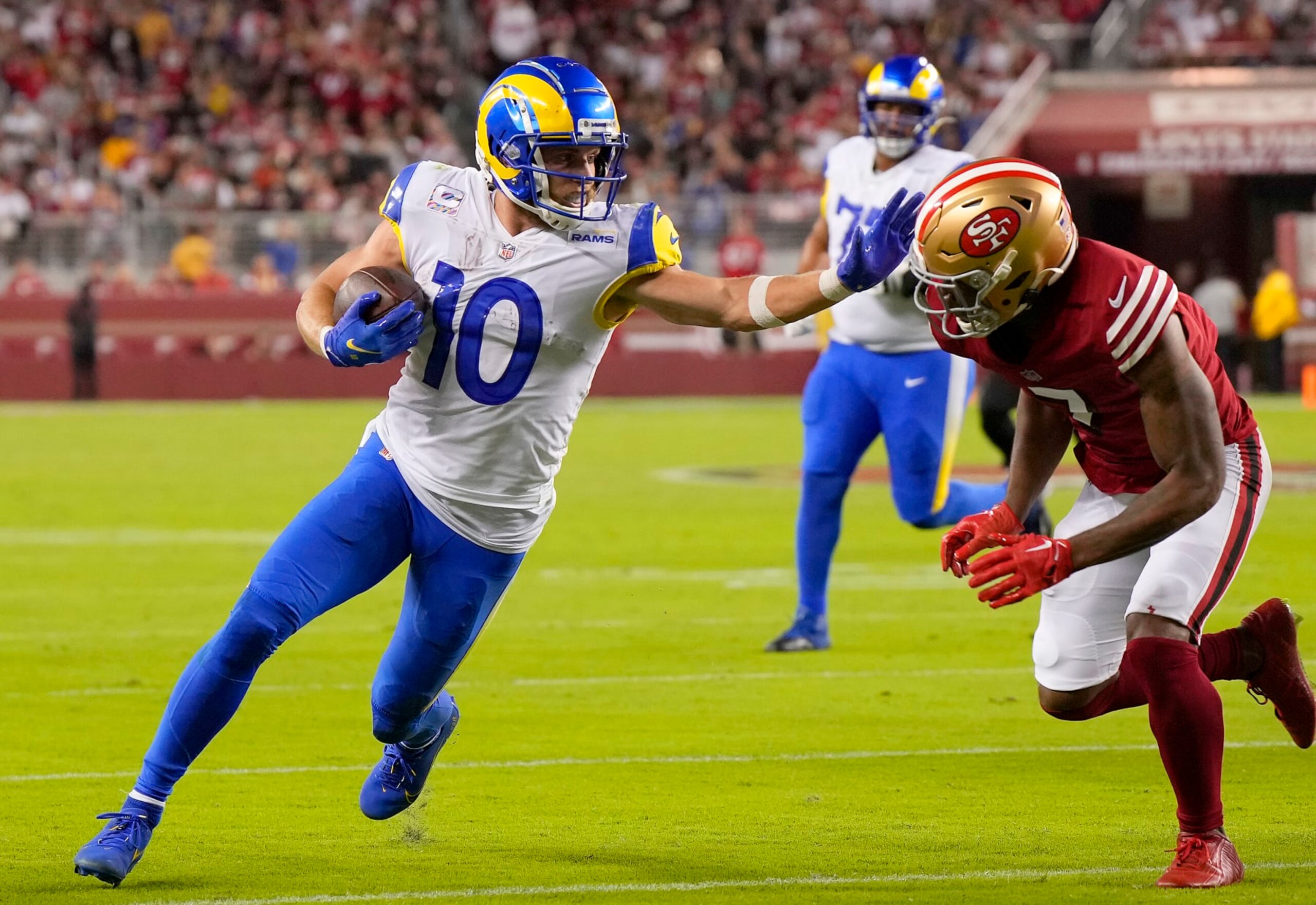 SANTA CLARA, CALIFORNIA - OCTOBER 03: Cooper Kupp #10 of the Los Angeles Rams fights off the tackle of Charvarius Ward #7 of the San Francisco 49ers in the third quarter at Levi's Stadium on October 03, 2022 in Santa Clara, California. (Photo by Thearon W. Henderson/Getty Images)