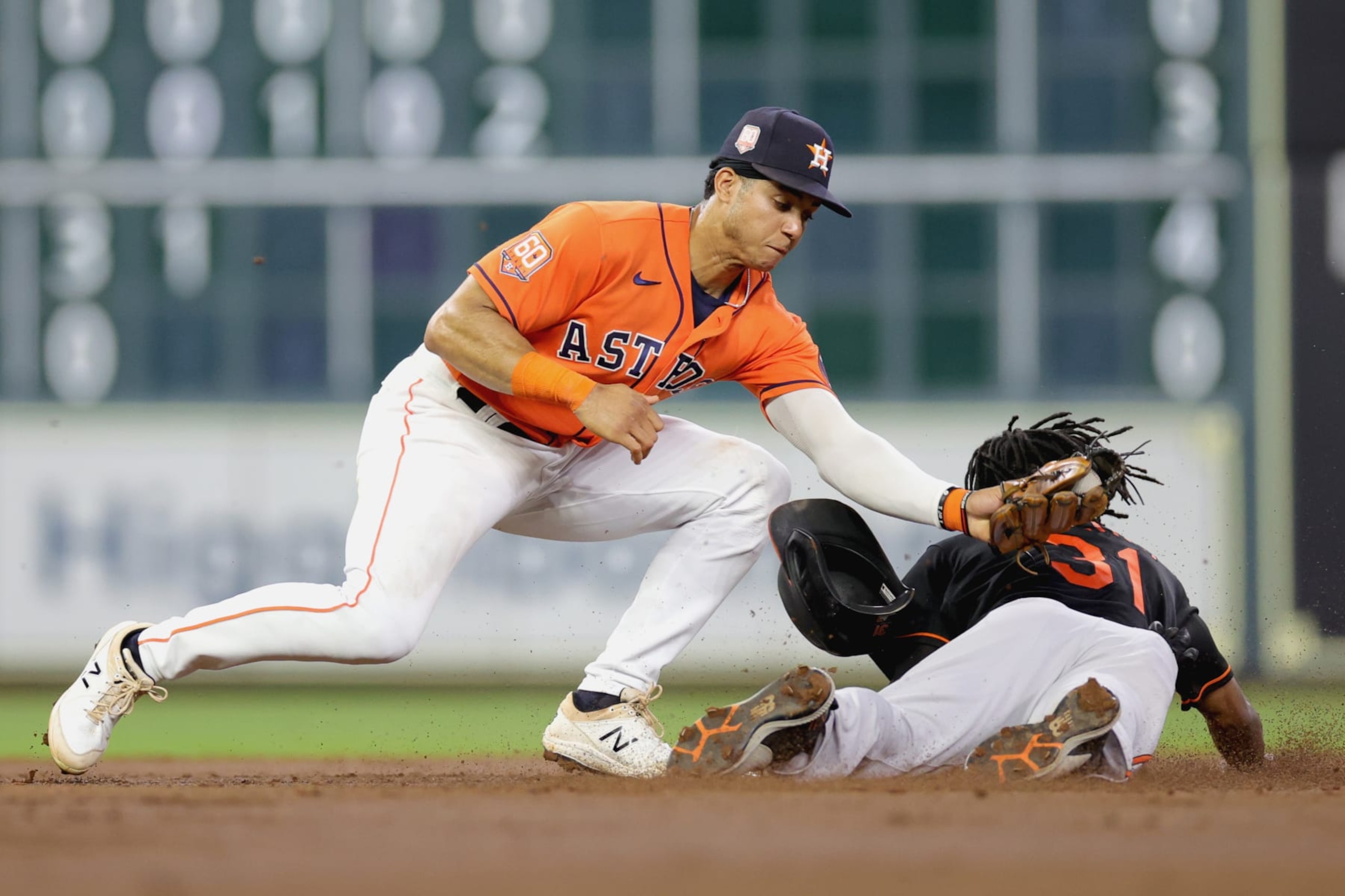 HOUSTON, TEXAS - AUGUST 26: Jeremy Pena #3 of the Houston Astros unable to tag out Cedric Mullins #31 of the Baltimore Orioles during the third inning at Minute Maid Park on August 26, 2022 in Houston, Texas. (Photo by Carmen Mandato/Getty Images)