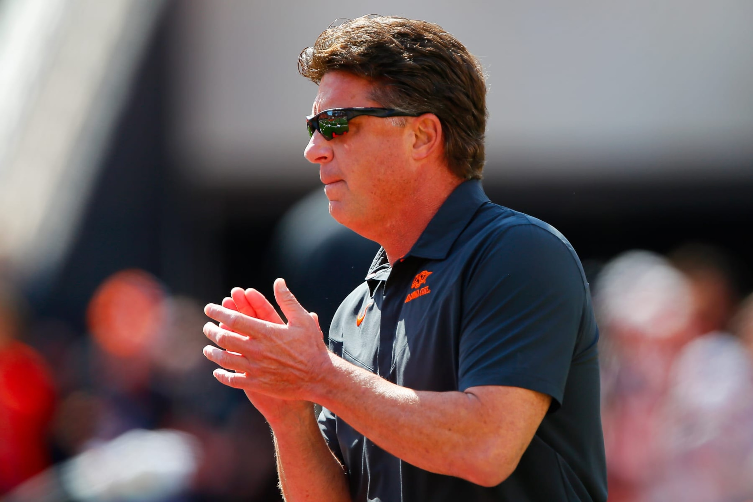 STILLWATER, OK - OCTOBER 8:  Head coach Mike Gundy of the Oklahoma State Cowboys cheers on his team as he walks onto the field for a game against the Texas Tech Red Raiders at Boone Pickens Stadium on October 8, 2022 in Stillwater, Oklahoma.   (Photo by Brian Bahr/Getty Images)