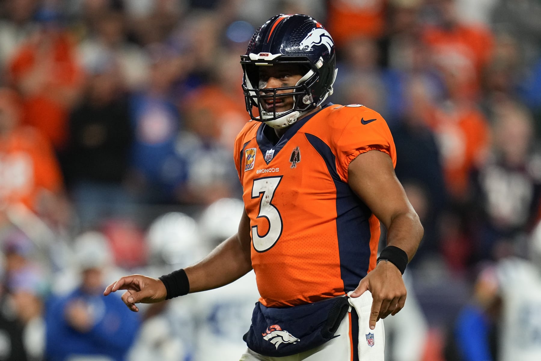 Denver Broncos quarterback Russell Wilson (3) looks at the defense of the Indianapolis Colts during an NFL football game, Thursday, Oct. 7, 2022, in Denver. (AP Photo/Jack Dempsey)