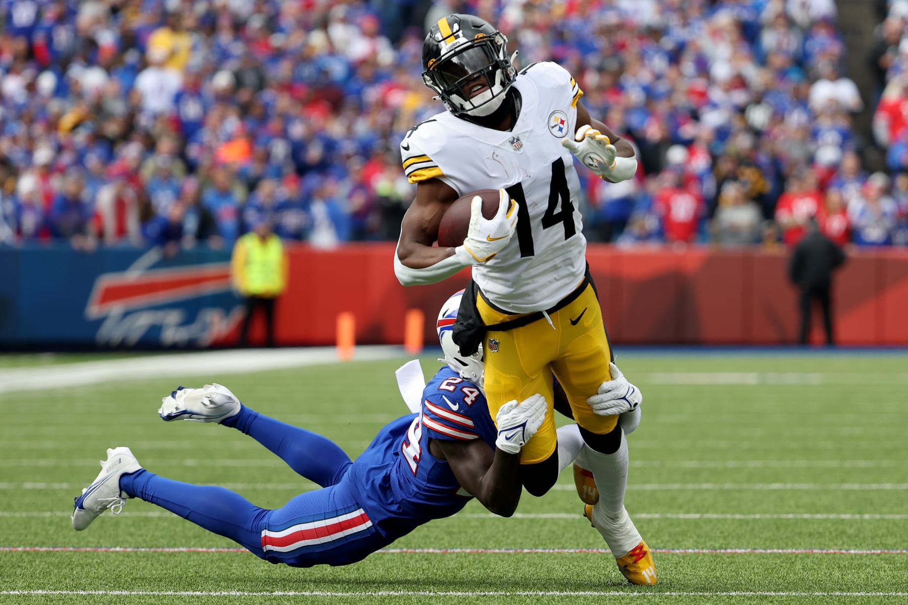 ORCHARD PARK, NEW YORK - OCTOBER 09: George Pickens #14 of the Pittsburgh Steelers is tackled by Kaiir Elam #24 of the Buffalo Bills during the first quarter at Highmark Stadium on October 09, 2022 in Orchard Park, New York. (Photo by Timothy T Ludwig/Getty Images)