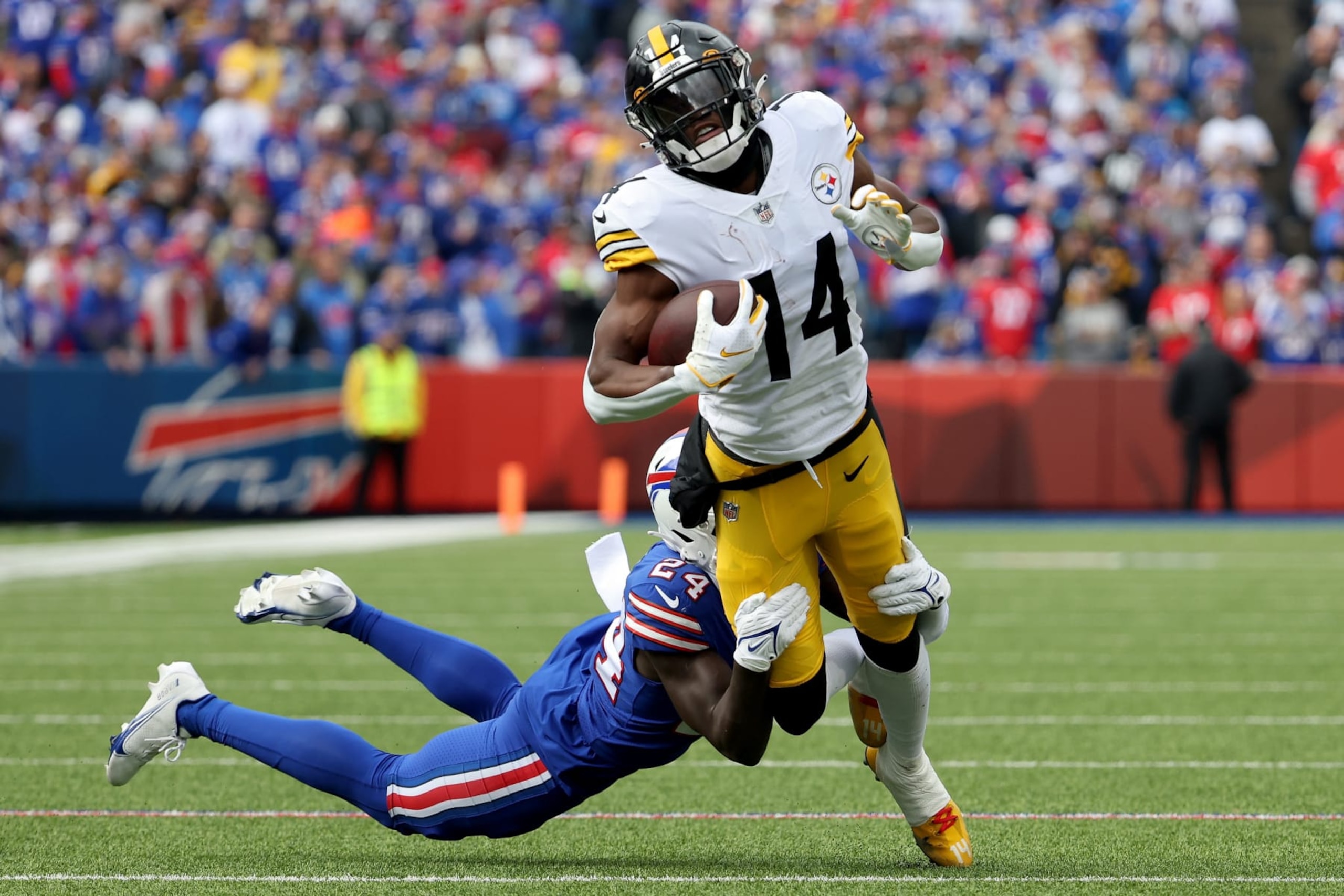 ORCHARD PARK, NEW YORK - OCTOBER 09: George Pickens #14 of the Pittsburgh Steelers is tackled by Kaiir Elam #24 of the Buffalo Bills during the first quarter at Highmark Stadium on October 09, 2022 in Orchard Park, New York. (Photo by Timothy T Ludwig/Getty Images)