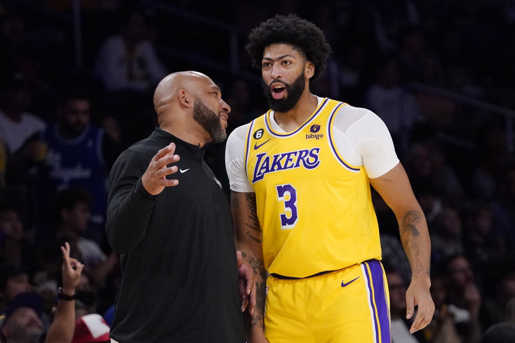 Los Angeles Lakers head coach Darvin Ham, left, talks with forward Anthony Davis during the first half of a preseason NBA basketball game against the Sacramento Kings Monday, Oct. 3, 2022, in Los Angeles. (AP Photo/Mark J. Terrill)