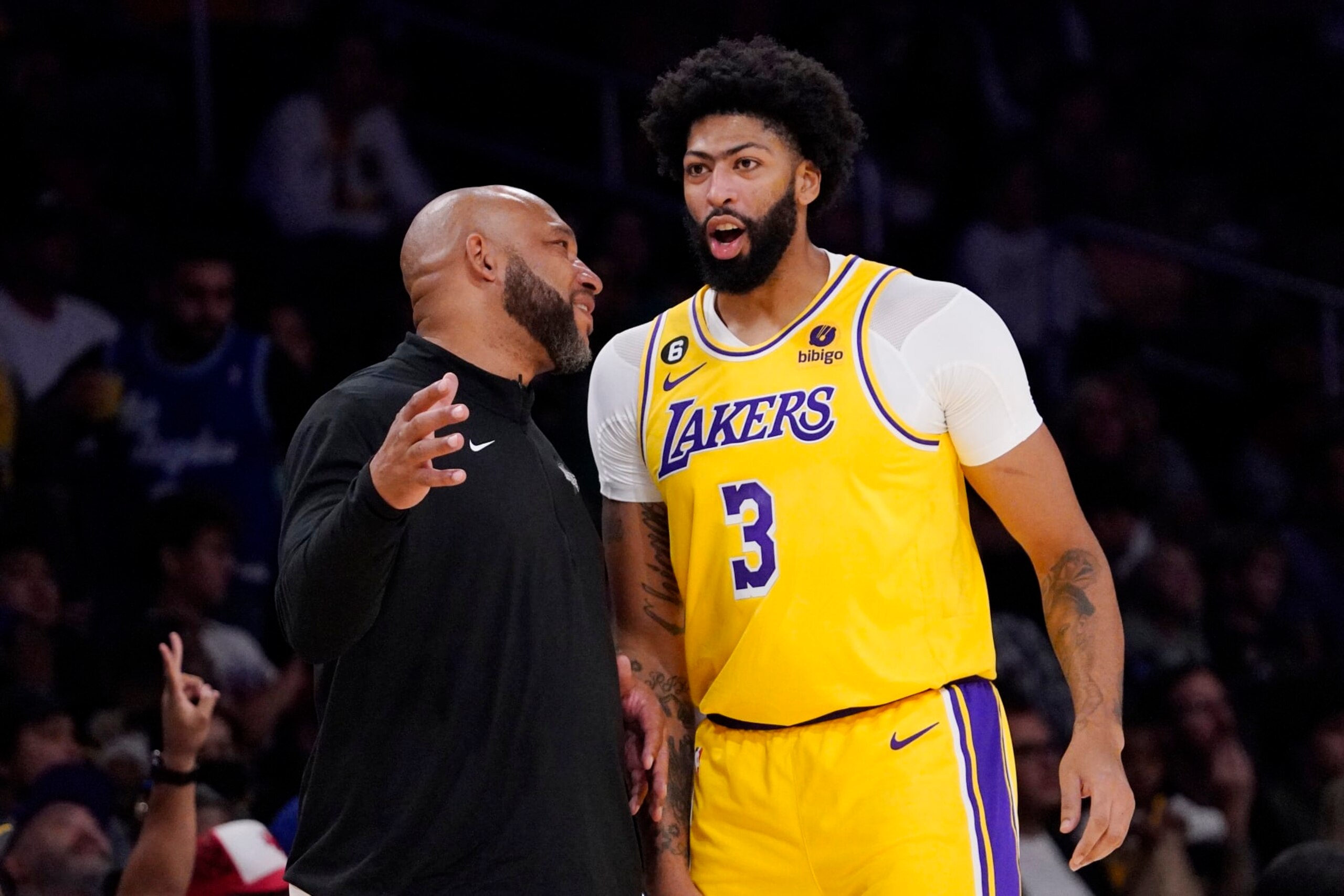 Los Angeles Lakers head coach Darvin Ham, left, talks with forward Anthony Davis during the first half of a preseason NBA basketball game against the Sacramento Kings Monday, Oct. 3, 2022, in Los Angeles. (AP Photo/Mark J. Terrill)