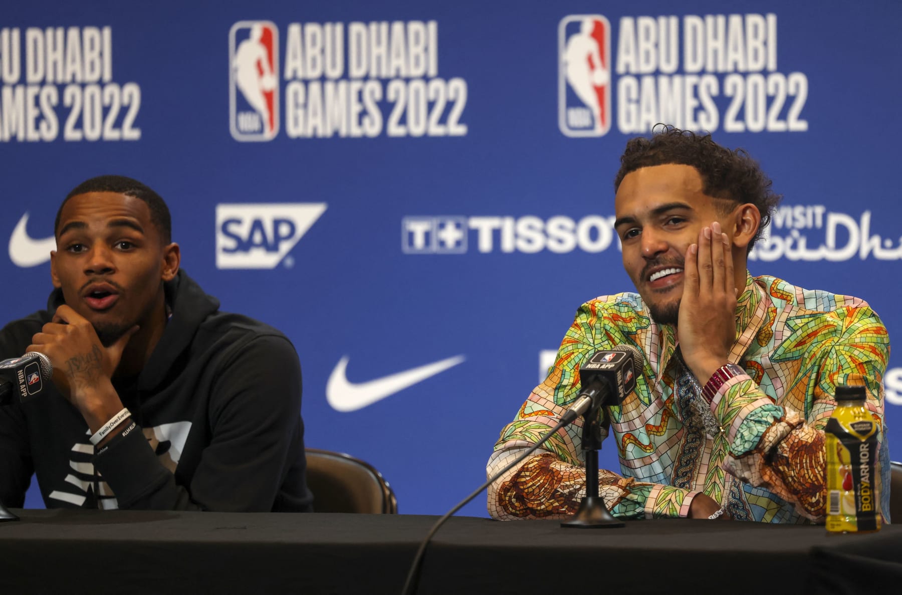 Atlanta Hawks' guard Trae Young (R) and Atlanta Hawks' guard Dejounte Murray attend a press conference after the NBA pre-season basketball match between the Milwaukee Bucks and the Atlanta Hawks at the Etihad Arena on Yas Island in Abu Dhabi, on October 6, 2022. (Photo by Karim SAHIB / AFP) (Photo by KARIM SAHIB/AFP via Getty Images)