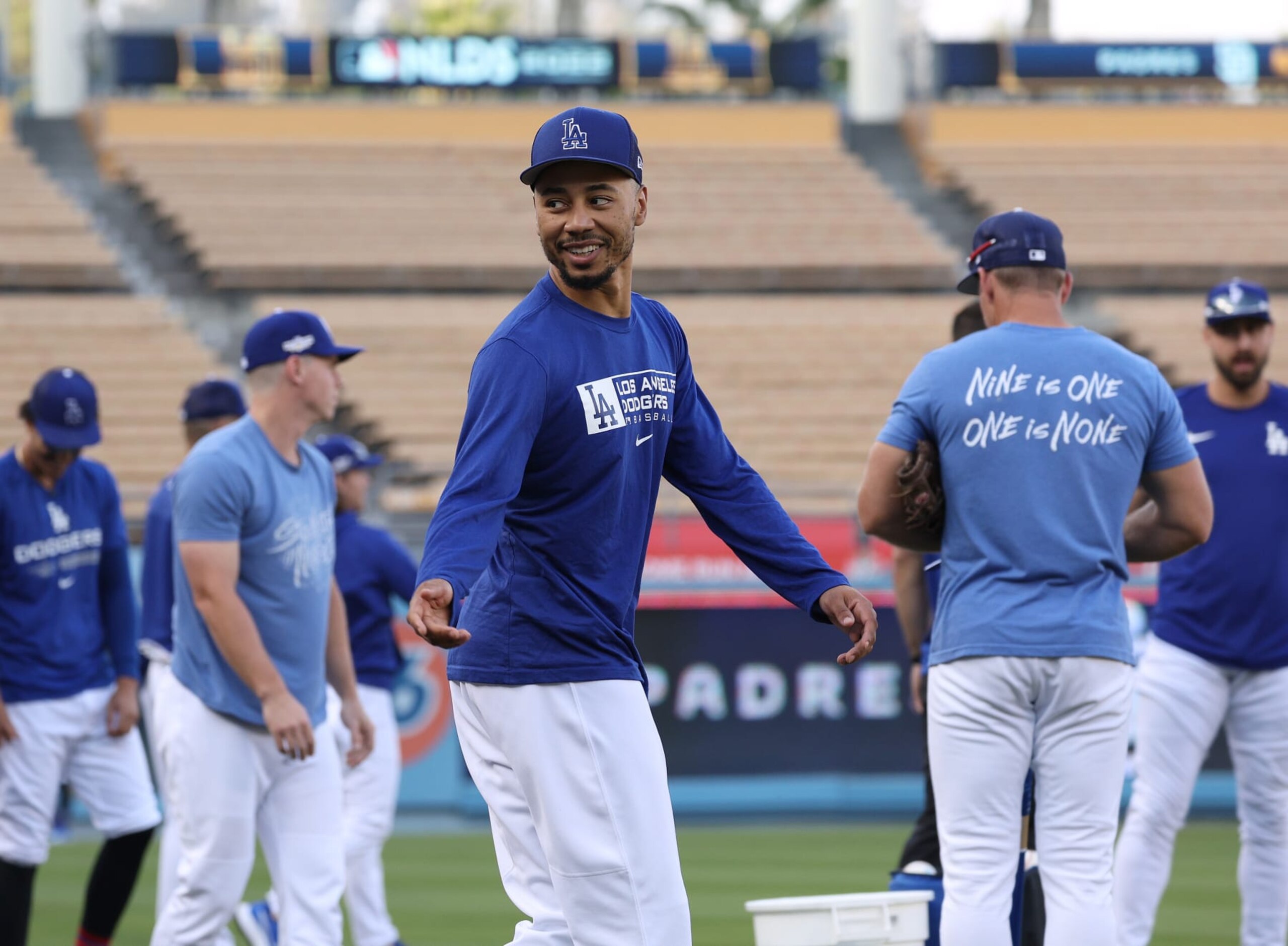 LOS ANGELES, CALIFORNIA - OCTOBER 10: Mookie Betts #50 of the Los Angeles Dodgers looks back as he walks on to the field during a workout before the MLB National League Division Series against the San Diego Padres at Dodger Stadium on October 10, 2022 in Los Angeles, California. (Photo by Harry How/Getty Images)