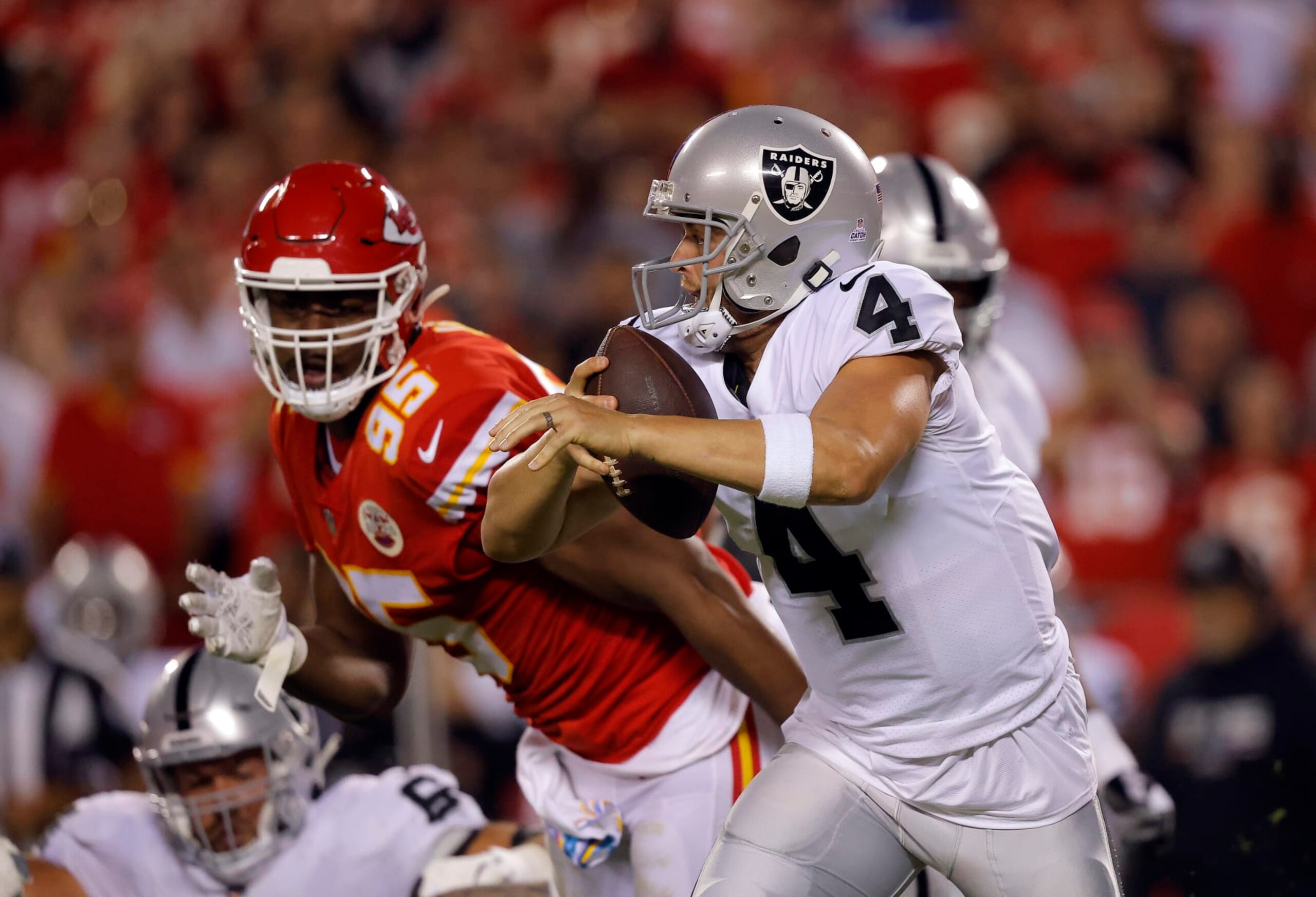 KANSAS CITY, MISSOURI - OCTOBER 10:  Derek Carr #4 of the Las Vegas Raiders scrambles as Chris Jones #95 of the Kansas City Chiefs chases during the 2nd quarter of the game at Arrowhead Stadium on October 10, 2022 in Kansas City, Missouri. (Photo by David Eulitt/Getty Images)