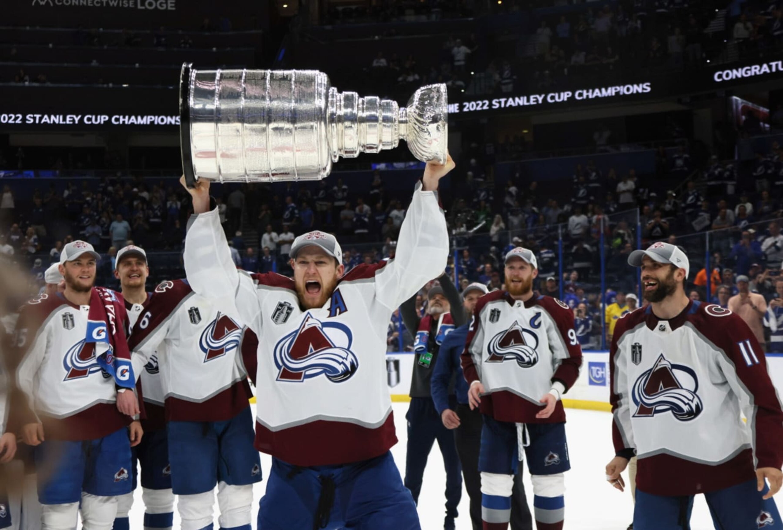TAMPA, FLORIDA - JUNE 26: Nathan MacKinnon #29 of the Colorado Avalanche carries the Stanley Cup following the series winning victory over the Tampa Bay Lightning in Game Six of the 2022 NHL Stanley Cup Final at Amalie Arena on June 26, 2022 in Tampa, Florida. (Photo by Bruce Bennett/Getty Images) TAMPA, FLORIDA - JUNE 26: Nathan MacKinnon #29 of the Colorado Avalanche carries the Stanley Cup following the series winning victory over the Tampa Bay Lightning in Game Six of the 2022 NHL Stanley Cup Final at Amalie Arena on June 26, 2022 in Tampa, Florida. (Photo by Bruce Bennett/Getty Images)