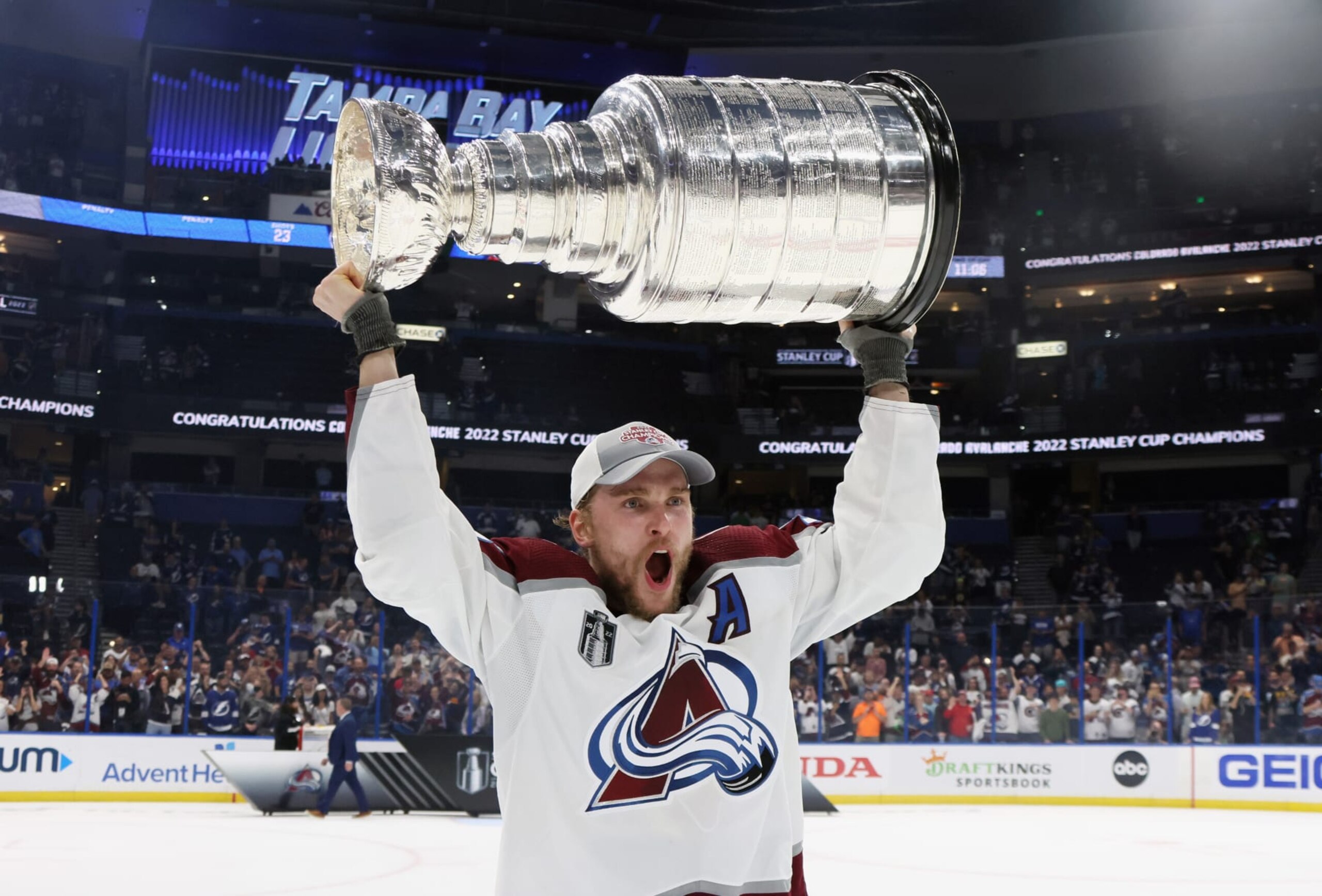 TAMPA, FLORIDA - JUNE 26: Mikko Rantanen #96 of the Colorado Avalanche carries the Stanley Cup following the series winning victory over the Tampa Bay Lightning in Game Six of the 2022 NHL Stanley Cup Final at Amalie Arena on June 26, 2022 in Tampa, Florida. (Photo by Bruce Bennett/Getty Images)