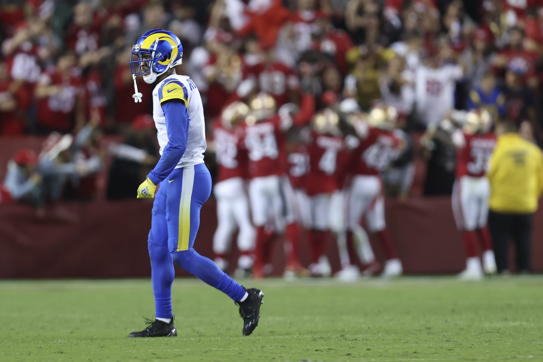 Los Angeles Rams wide receiver Allen Robinson II, foreground, walks off the field as San Francisco 49ers players celebrate after safety Talanoa Hufanga scored on an interception return during the second half of an NFL football game in Santa Clara, Calif., Monday, Oct. 3, 2022. (AP Photo/Jed Jacobsohn)