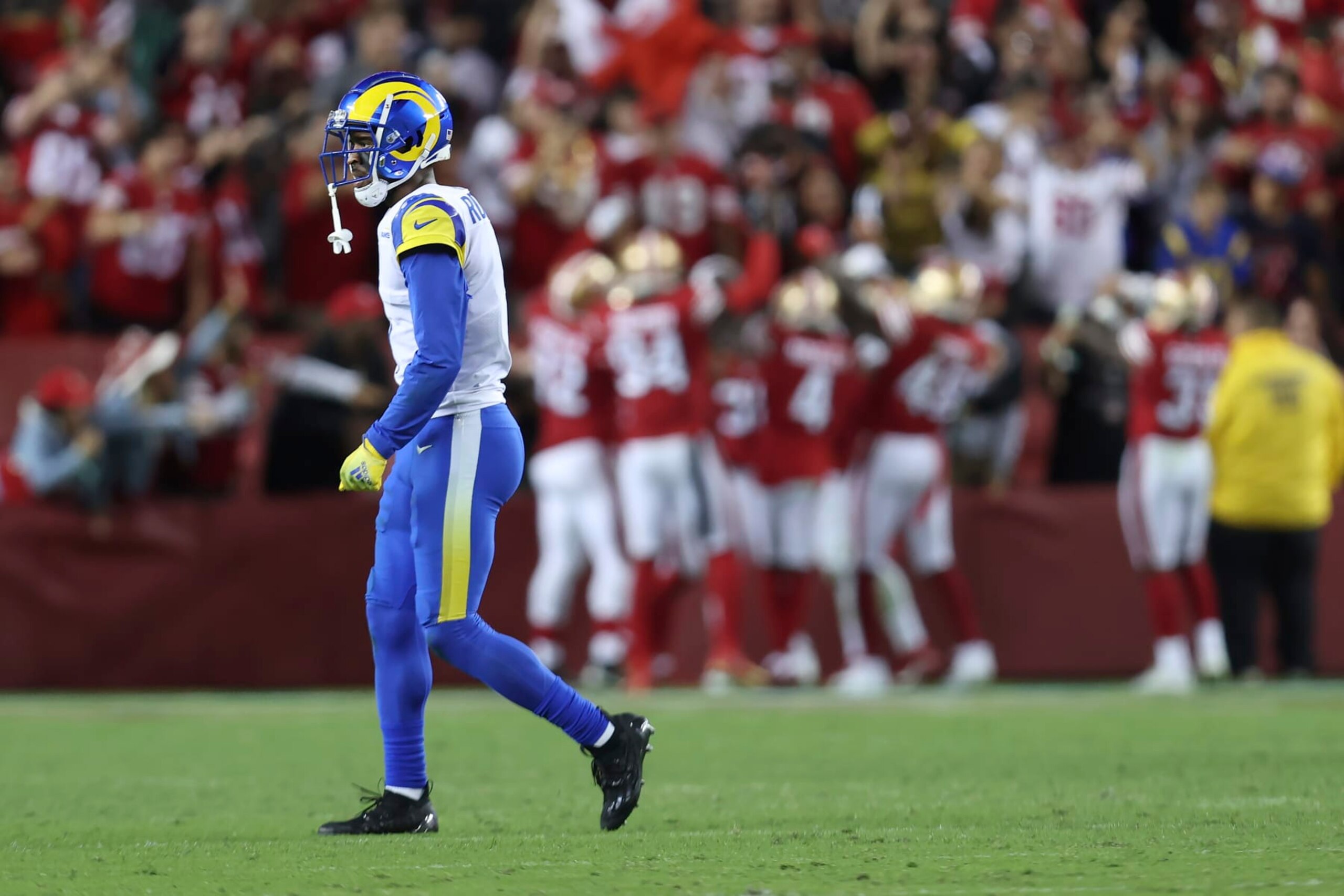 Los Angeles Rams wide receiver Allen Robinson II, foreground, walks off the field as San Francisco 49ers players celebrate after safety Talanoa Hufanga scored on an interception return during the second half of an NFL football game in Santa Clara, Calif., Monday, Oct. 3, 2022. (AP Photo/Jed Jacobsohn)