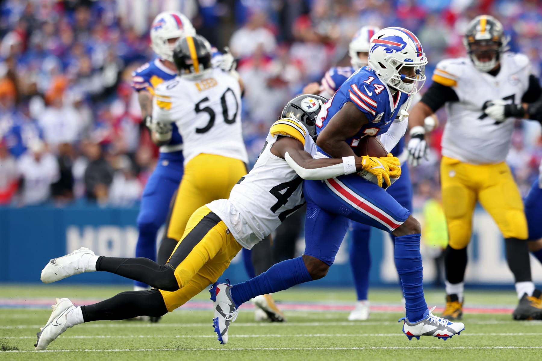 ORCHARD PARK, NEW YORK - OCTOBER 09: Stefon Diggs #14 of the Buffalo Bills is tackled by James Pierre #42 of the Pittsburgh Steelers during the third quarter at Highmark Stadium on October 09, 2022 in Orchard Park, New York. (Photo by Bryan M. Bennett/Getty Images)