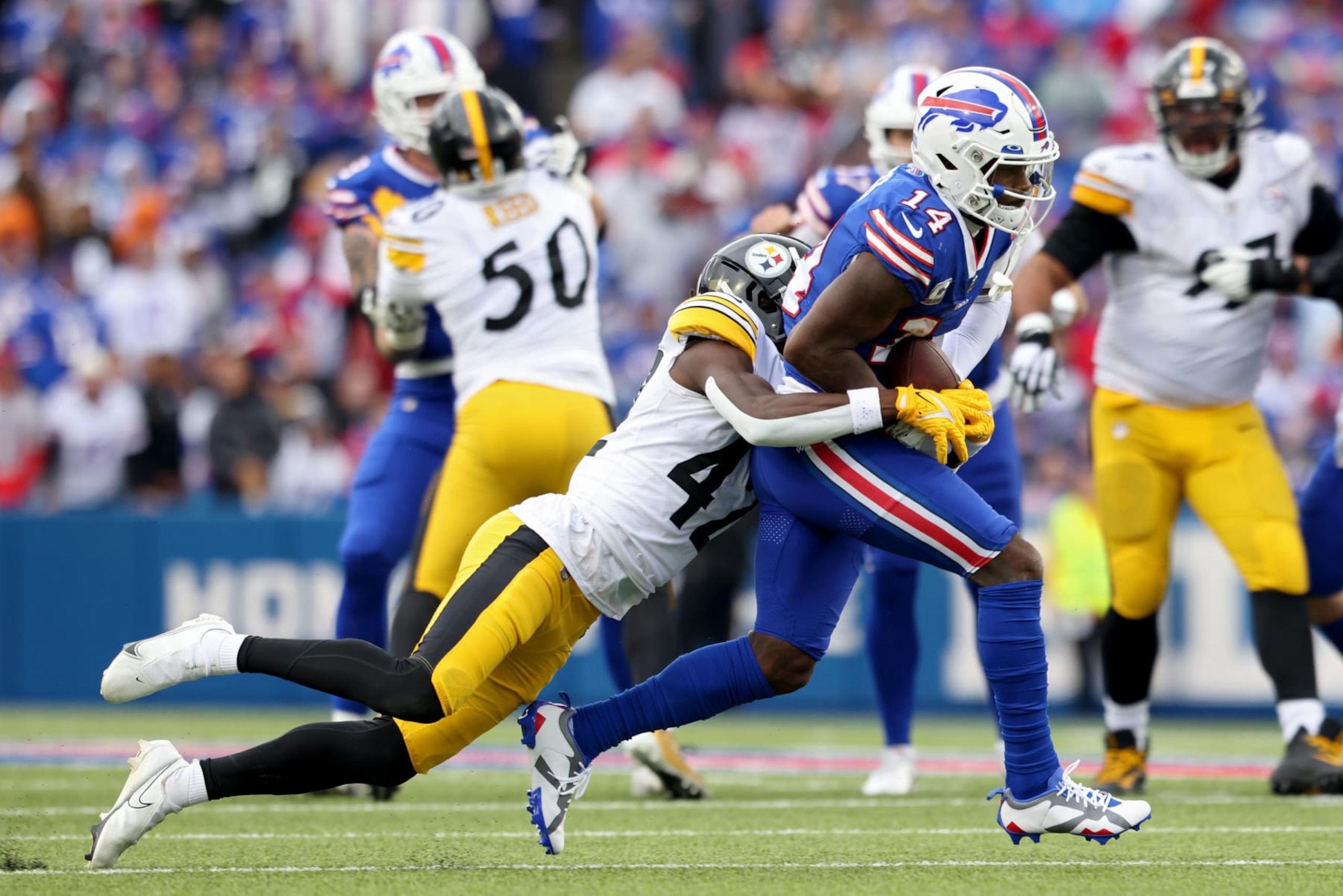 ORCHARD PARK, NEW YORK - OCTOBER 09: Stefon Diggs #14 of the Buffalo Bills is tackled by James Pierre #42 of the Pittsburgh Steelers during the third quarter at Highmark Stadium on October 09, 2022 in Orchard Park, New York. (Photo by Bryan M. Bennett/Getty Images)