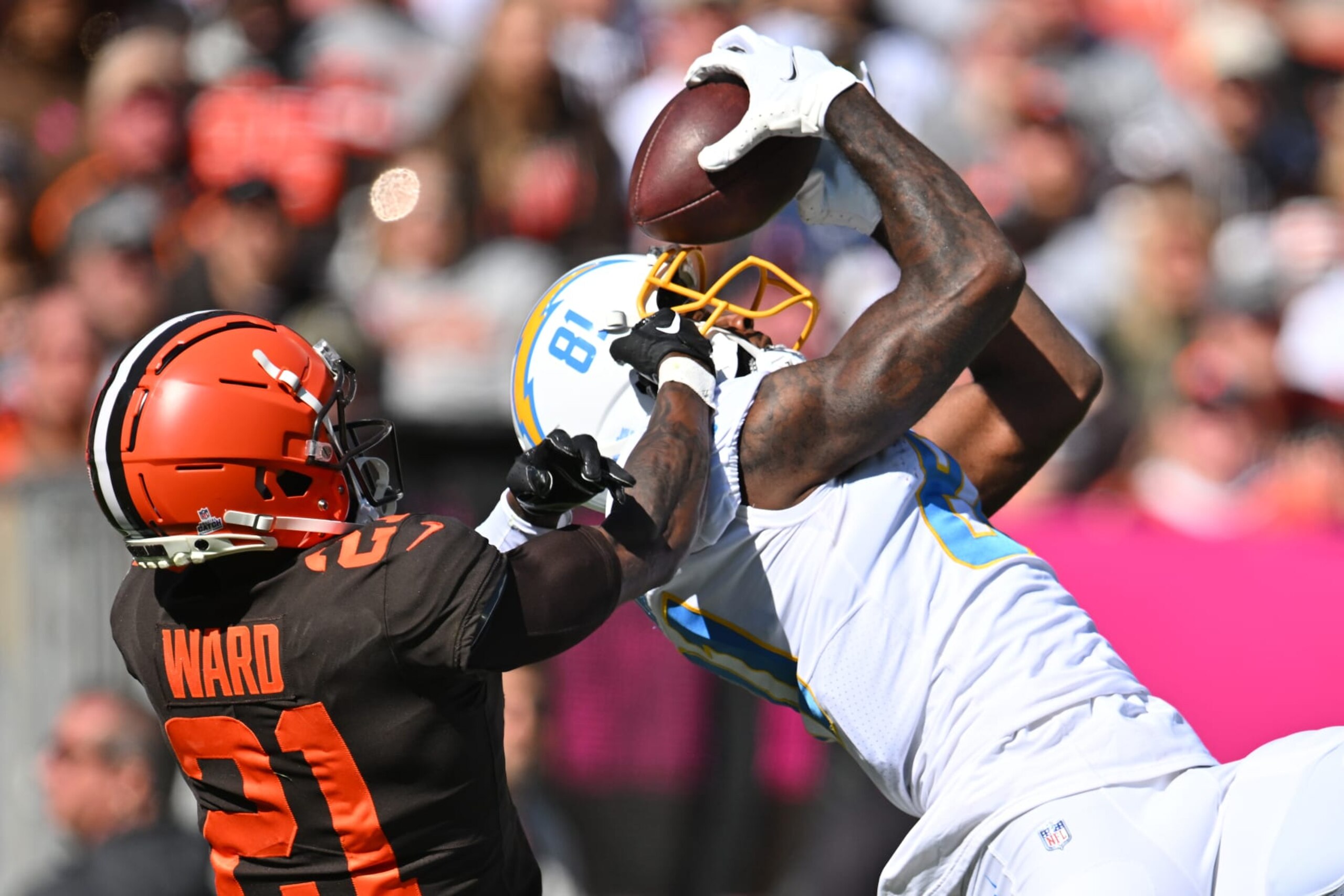 CLEVELAND, OHIO - OCTOBER 09: Mike Williams #81 of the Los Angeles Chargers catches a pass in front of Denzel Ward #21 of the Cleveland Browns during the first quarter at FirstEnergy Stadium on October 09, 2022 in Cleveland, Ohio. (Photo by Jason Miller/Getty Images)