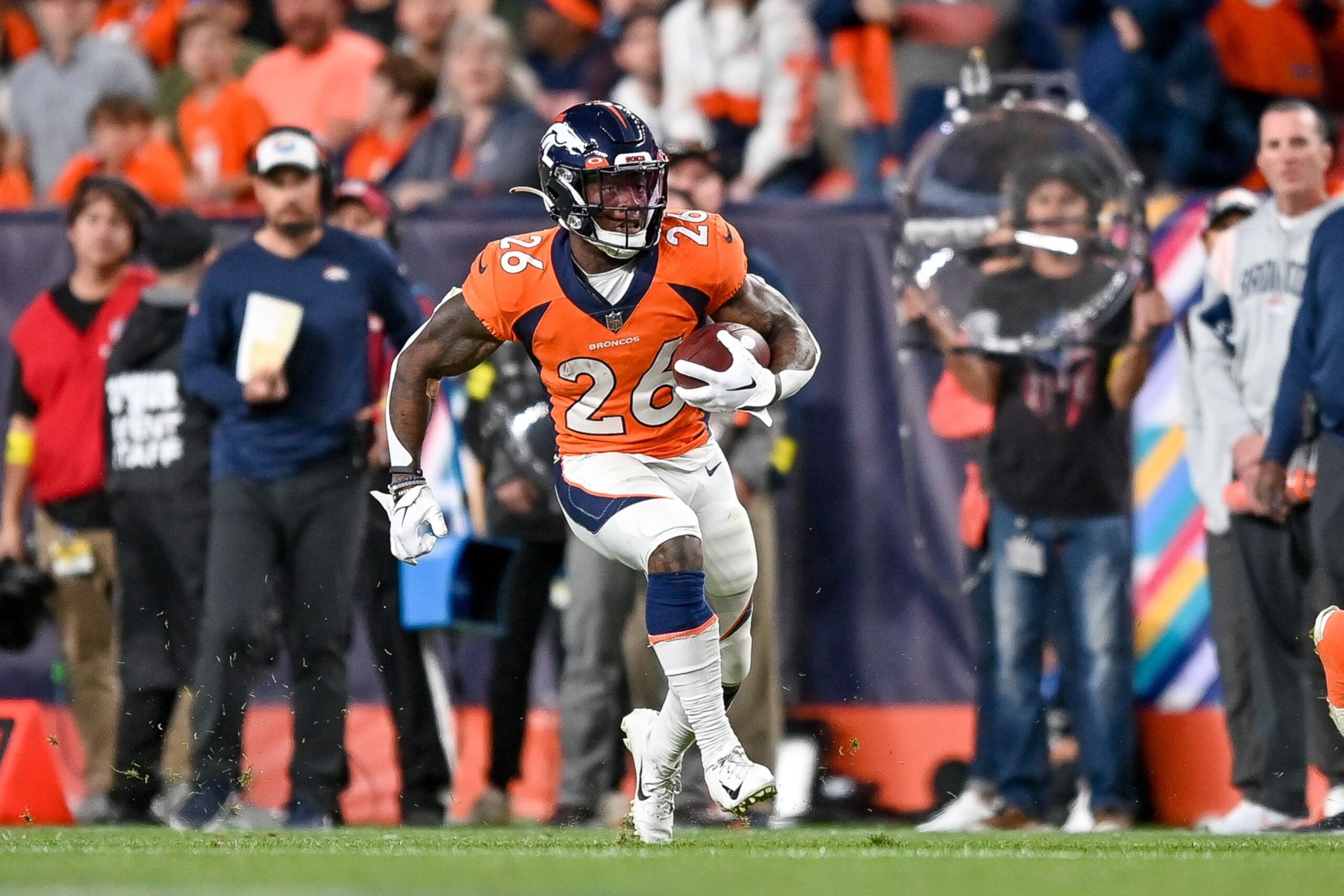 DENVER, COLORADO - OCTOBER 6: Running back Mike Boone #26 of the Denver Broncos carries the ball against the Indianapolis Colts at Empower Field at Mile High on October 6, 2022 in Denver, Colorado. (Photo by Dustin Bradford/Getty Images) DENVER, COLORADO - OCTOBER 6: Running back Mike Boone #26 of the Denver Broncos carries the ball against the Indianapolis Colts at Empower Field at Mile High on October 6, 2022 in Denver, Colorado. (Photo by Dustin Bradford/Getty Images)
