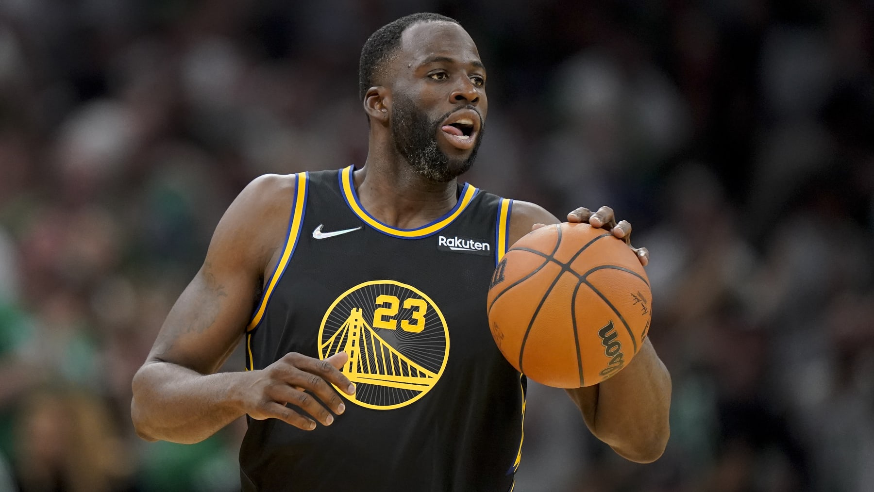 Golden State Warriors forward Draymond Green (23) brings the ball up court against the Boston Celtics during the fourth quarter of Game 4 of basketball's NBA Finals, Friday, June 10, 2022, in Boston. (AP Photo/Steven Senne)