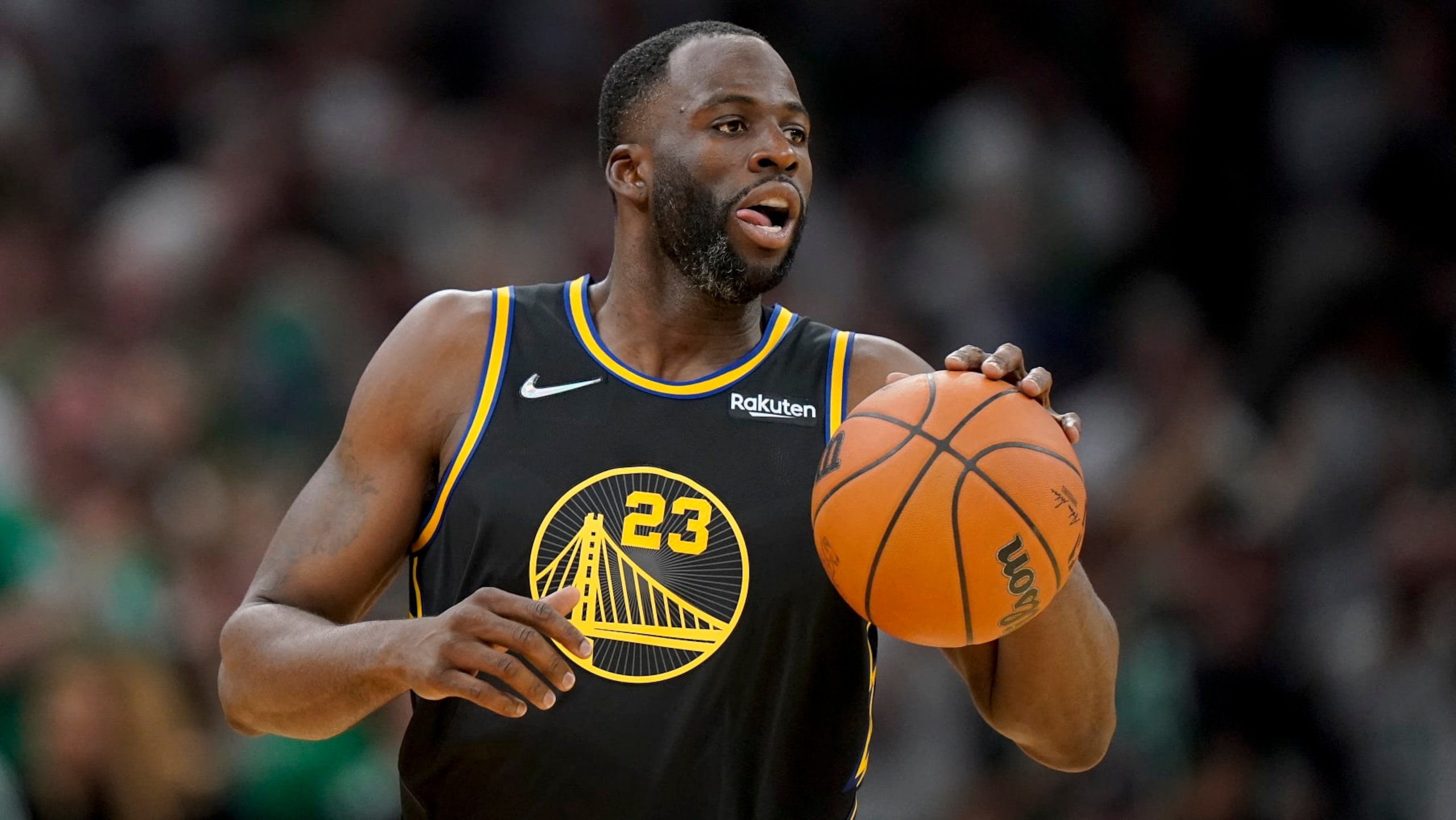 Golden State Warriors forward Draymond Green (23) brings the ball up court against the Boston Celtics during the fourth quarter of Game 4 of basketball's NBA Finals, Friday, June 10, 2022, in Boston. (AP Photo/Steven Senne)