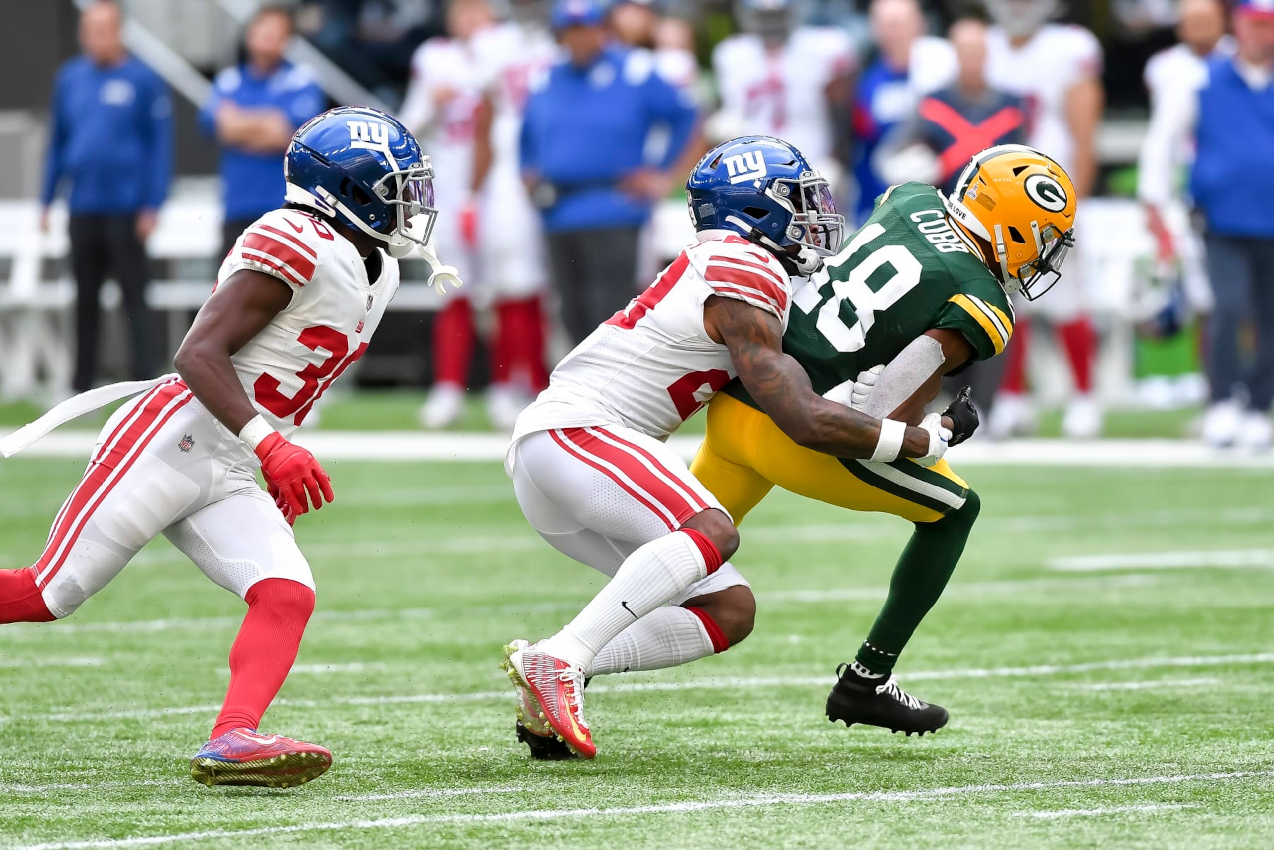 LONDON, ENGLAND - OCTOBER 09: Darnay Holmes of New York Giants, Xavier McKinney of New York Giants and Randall Cobb of Green Bay Packers with a tackle during battle for the ball during the NFL match between New York Giants and Green Bay Packers at Tottenham Hotspur Stadium on October 9, 2022 in London, England. (Photo by Vincent Mignott/DeFodi Images via Getty Images) LONDON, ENGLAND - OCTOBER 09: Darnay Holmes of New York Giants, Xavier McKinney of New York Giants and Randall Cobb of Green Bay Packers with a tackle during battle for the ball during the NFL match between New York Giants and Green Bay Packers at Tottenham Hotspur Stadium on October 9, 2022 in London, England. (Photo by Vincent Mignott/DeFodi Images via Getty Images)