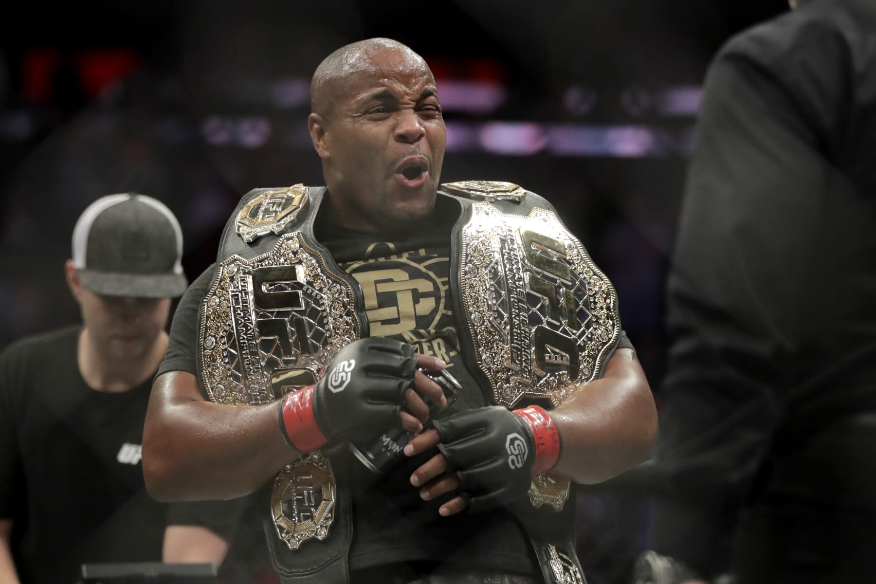 FILE - Daniel Cormier reacts after defeating Derrick Lewis by submission in the second round of a heavyweight mixed martial arts bout at UFC 230, early Sunday, Nov. 4, 2018, at Madison Square Garden in New York. Cormier insisted he retired from MMA competition. So what was the two-time UFC heavyweight champion doing again Saturday night inside a cage? Cormier was the guest referee at a WWE event and he told The Associated Press after the card he's thinking of following in the path of Ronda Rousey and Brock Lesnar and making the jump to the squared circle. (AP Photo/Julio Cortez, File)