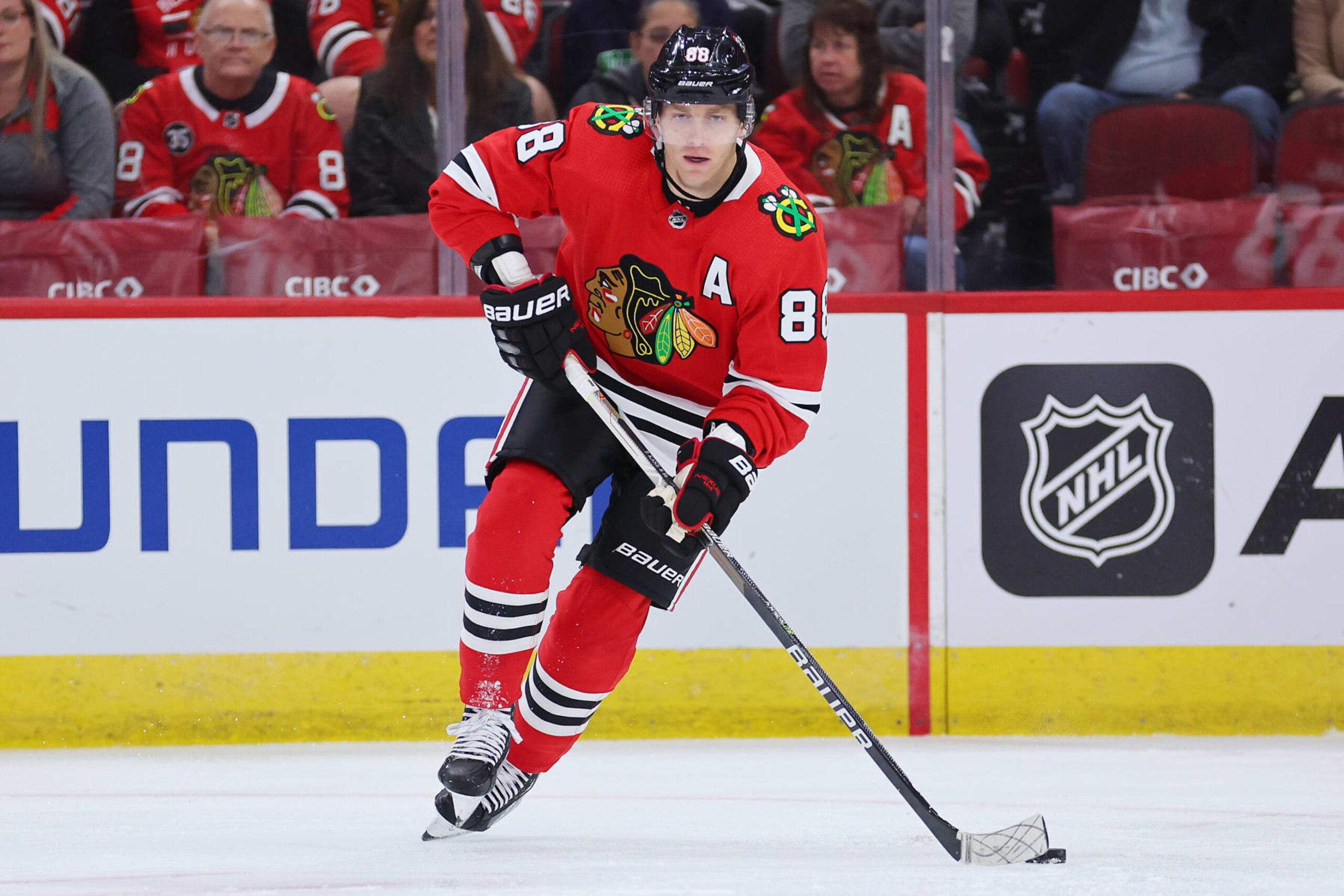 CHICAGO, ILLINOIS - SEPTEMBER 27: Patrick Kane #88 of the Chicago Blackhawks skates with the puck against the St. Louis Blues during the first period of a preseason game at United Center on September 27, 2022 in Chicago, Illinois. (Photo by Michael Reaves/Getty Images)