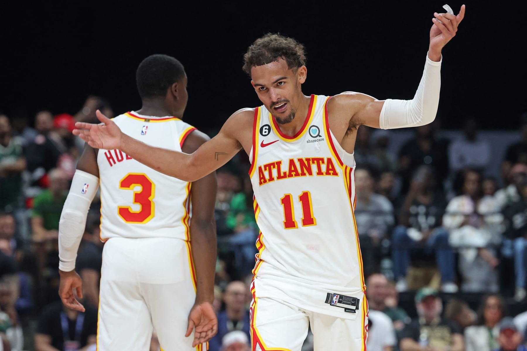 Atlanta Hawks' guard Trae Young reacts during the NBA pre-season basketball match between the Milwaukee Bucks and the Atlanta Hawks at the Etihad Arena on Yas Island in Abu Dhabi, on October 8, 2022. (Photo by Giuseppe CACACE / AFP) (Photo by GIUSEPPE CACACE/AFP via Getty Images)