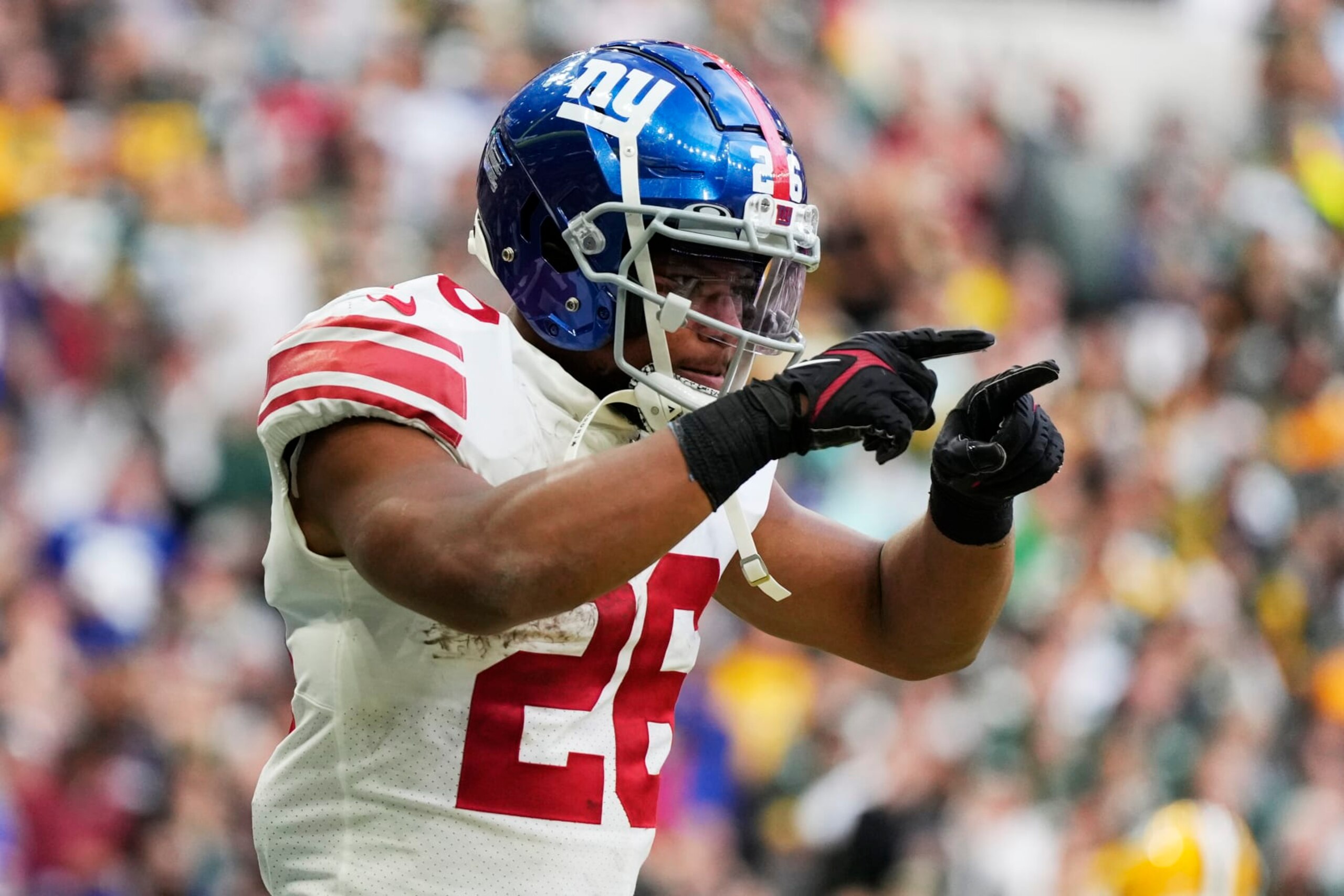 New York Giants running back Saquon Barkley (26) celebrates a touchdown during the second half of an NFL football game against the Green Bay Packers at the Tottenham Hotspur stadium in London, Sunday, Oct. 9, 2022. (AP Photo/Alastair Grant)