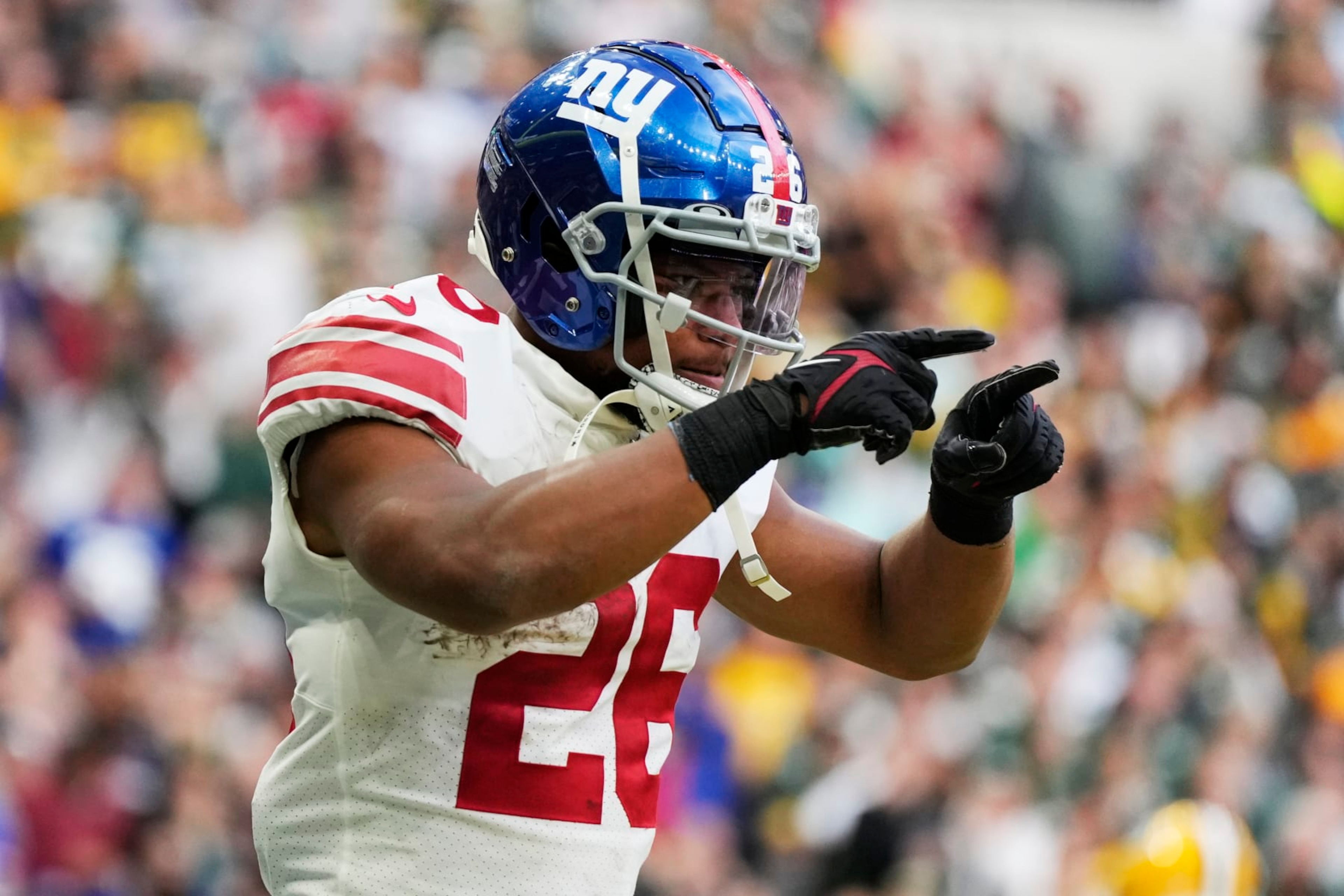 New York Giants running back Saquon Barkley (26) celebrates a touchdown during the second half of an NFL football game against the Green Bay Packers at the Tottenham Hotspur stadium in London, Sunday, Oct. 9, 2022. (AP Photo/Alastair Grant) New York Giants running back Saquon Barkley (26) celebrates a touchdown during the second half of an NFL football game against the Green Bay Packers at the Tottenham Hotspur stadium in London, Sunday, Oct. 9, 2022. (AP Photo/Alastair Grant)