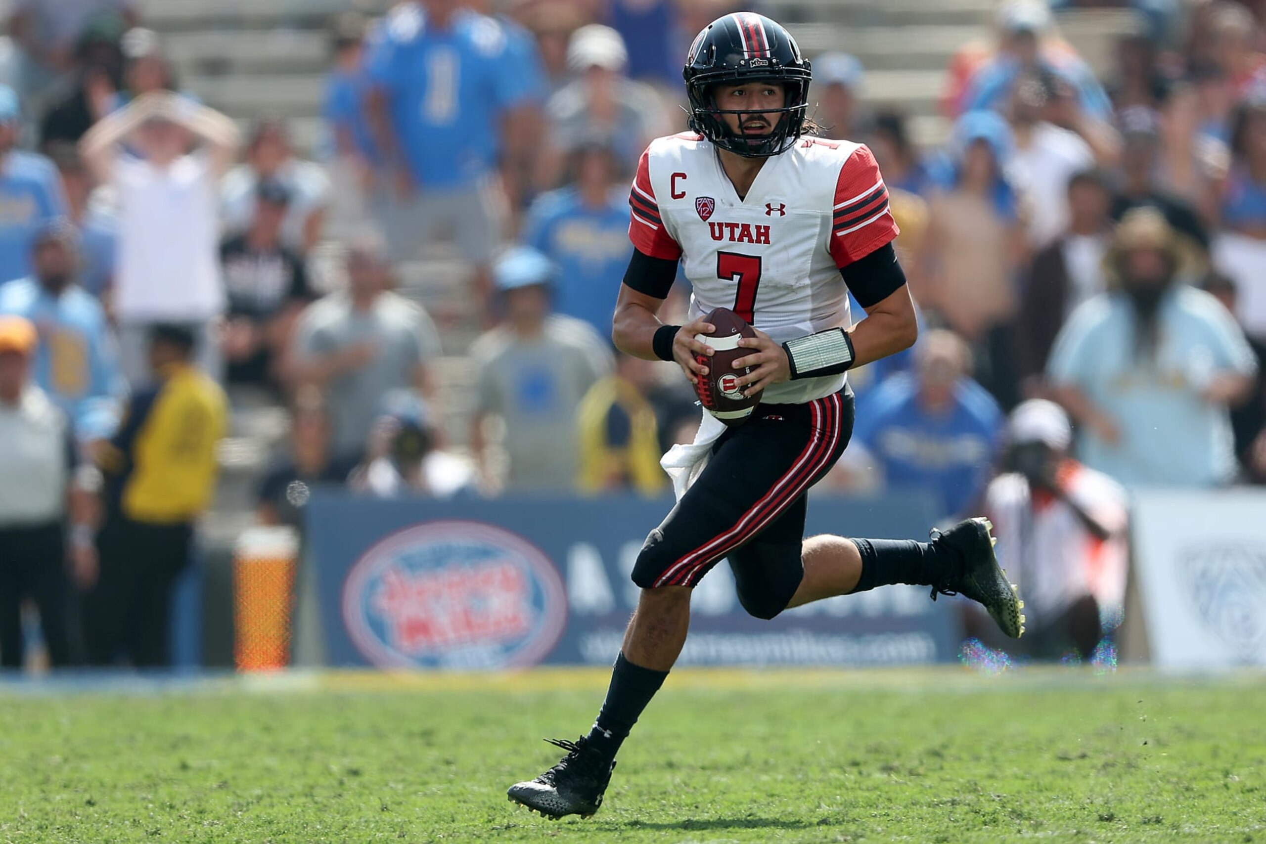 PASADENA, CALIFORNIA - OCTOBER 08: Cameron Rising #7 of the Utah Utes rolls out during the first half of a game against the UCLA Bruins at Rose Bowl on October 08, 2022 in Pasadena, California. (Photo by Sean M. Haffey/Getty Images)