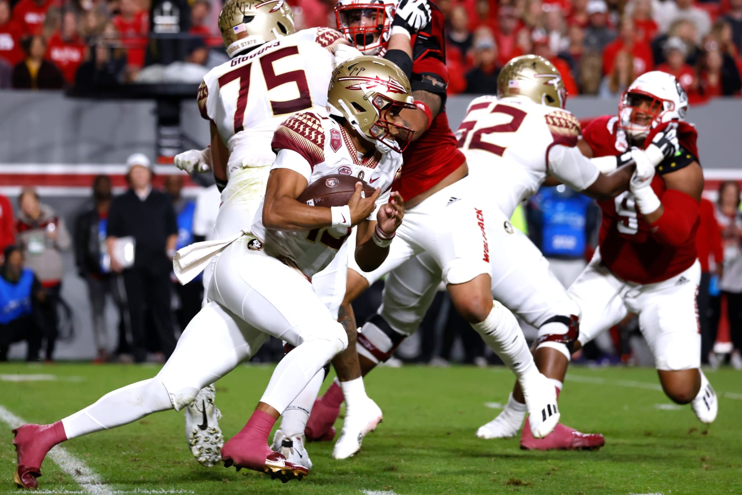RALEIGH, NC - OCTOBER 08: Jordan Travis #13 of the Florida State Seminoles runs with the ball during the first half of their game against the North Carolina State Wolfpack at Carter-Finley Stadium on October 8, 2022 in Raleigh, North Carolina. (Photo by Lance King/Getty Images)