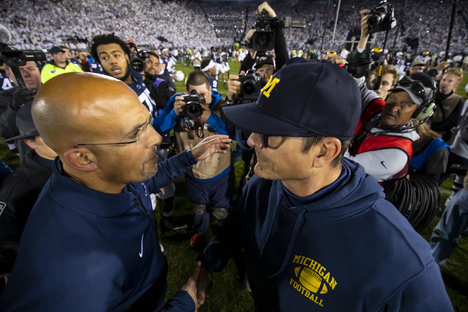 UNIVERSITY PARK, PA - OCTOBER 19:  (L-R) Head coach James Franklin of the Penn State Nittany Lions shakes hands with head coach Jim Harbaugh of the Michigan Wolverines after the game on October 19, 2019 at Beaver Stadium in University Park, Pennsylvania. Penn State defeats Michigan 28-21.  (Photo by Brett Carlsen/Getty Images)