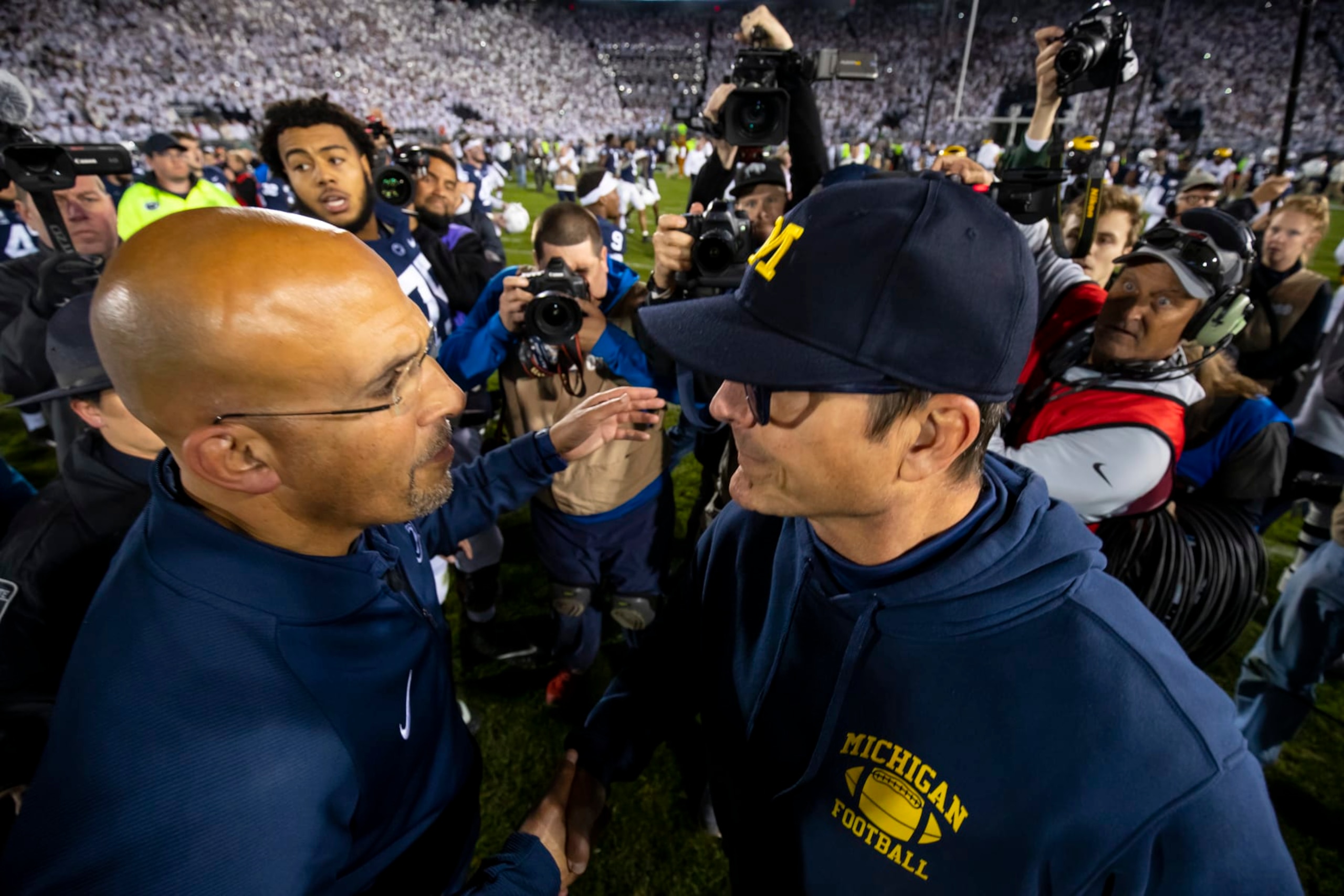 UNIVERSITY PARK, PA - OCTOBER 19:  (L-R) Head coach James Franklin of the Penn State Nittany Lions shakes hands with head coach Jim Harbaugh of the Michigan Wolverines after the game on October 19, 2019 at Beaver Stadium in University Park, Pennsylvania. Penn State defeats Michigan 28-21.  (Photo by Brett Carlsen/Getty Images)