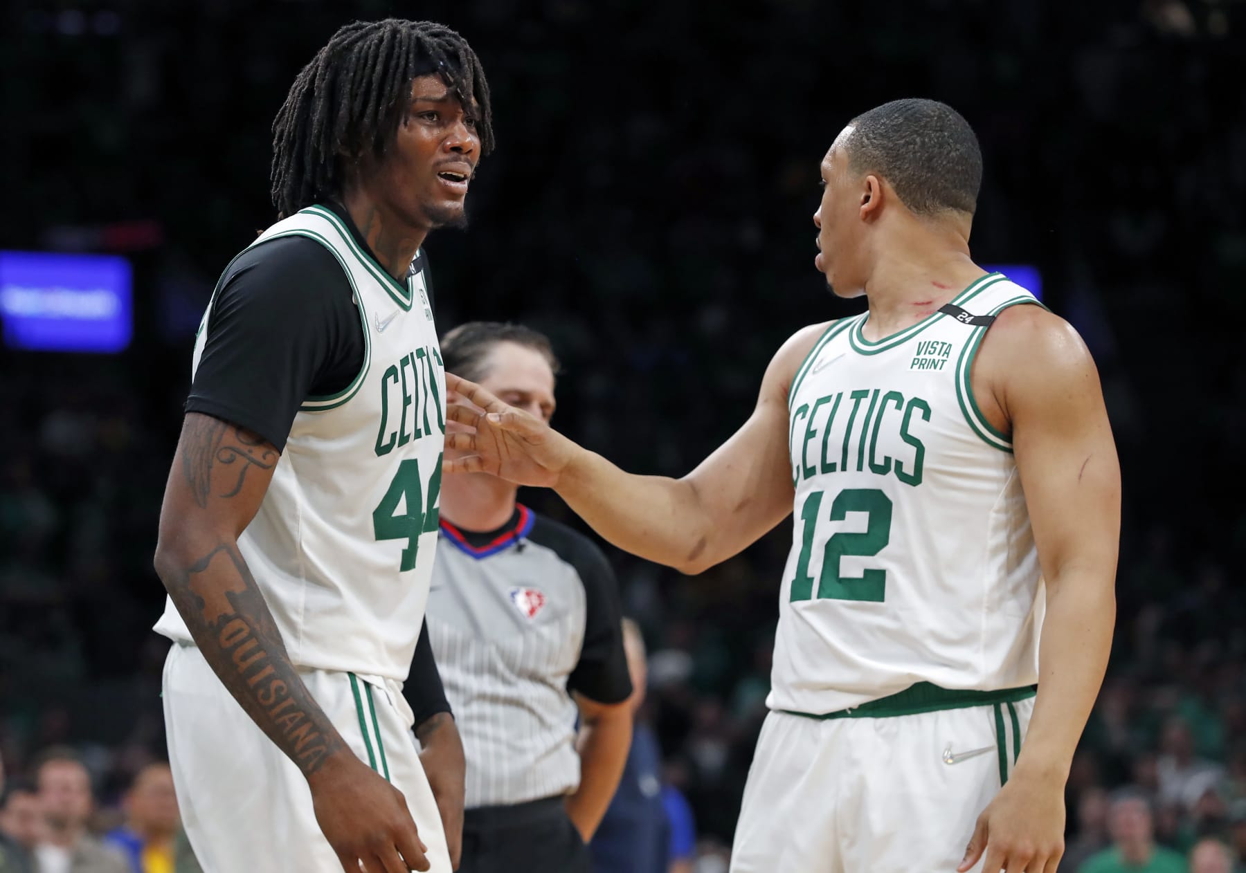 Boston - June 16: The Celtics Robert Williams (left) is upset when he was called for a second quarter foul, teammate Grant Williams (right) tries to keep him away from the referee. The Boston Celtics hosted the Golden State Warriors for Game Six of the NBA Finals at the TD Garden in Boston on June 17, 2022. (Photo by Jim Davis/The Boston Globe via Getty Images)