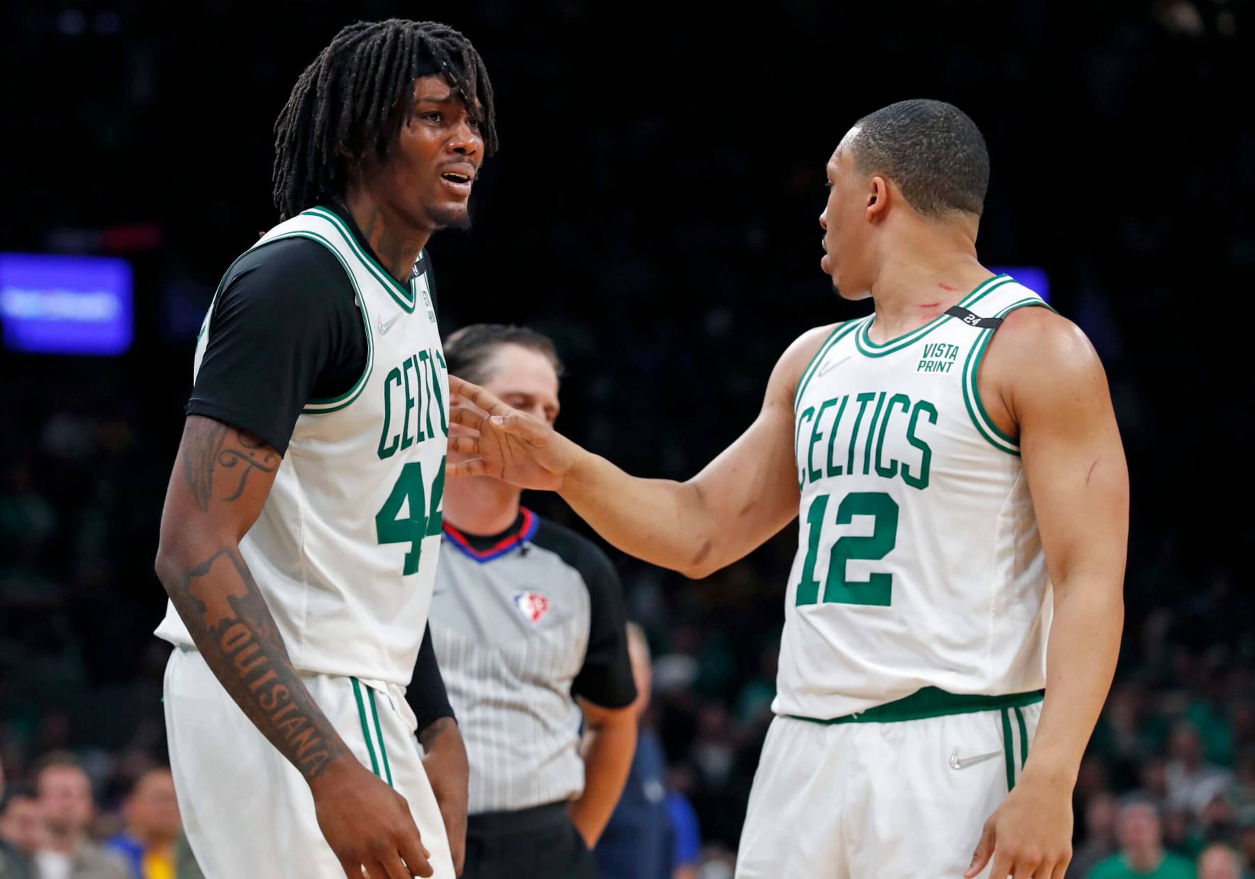 Boston - June 16: The Celtics Robert Williams (left) is upset when he was called for a second quarter foul, teammate Grant Williams (right) tries to keep him away from the referee. The Boston Celtics hosted the Golden State Warriors for Game Six of the NBA Finals at the TD Garden in Boston on June 17, 2022. (Photo by Jim Davis/The Boston Globe via Getty Images)