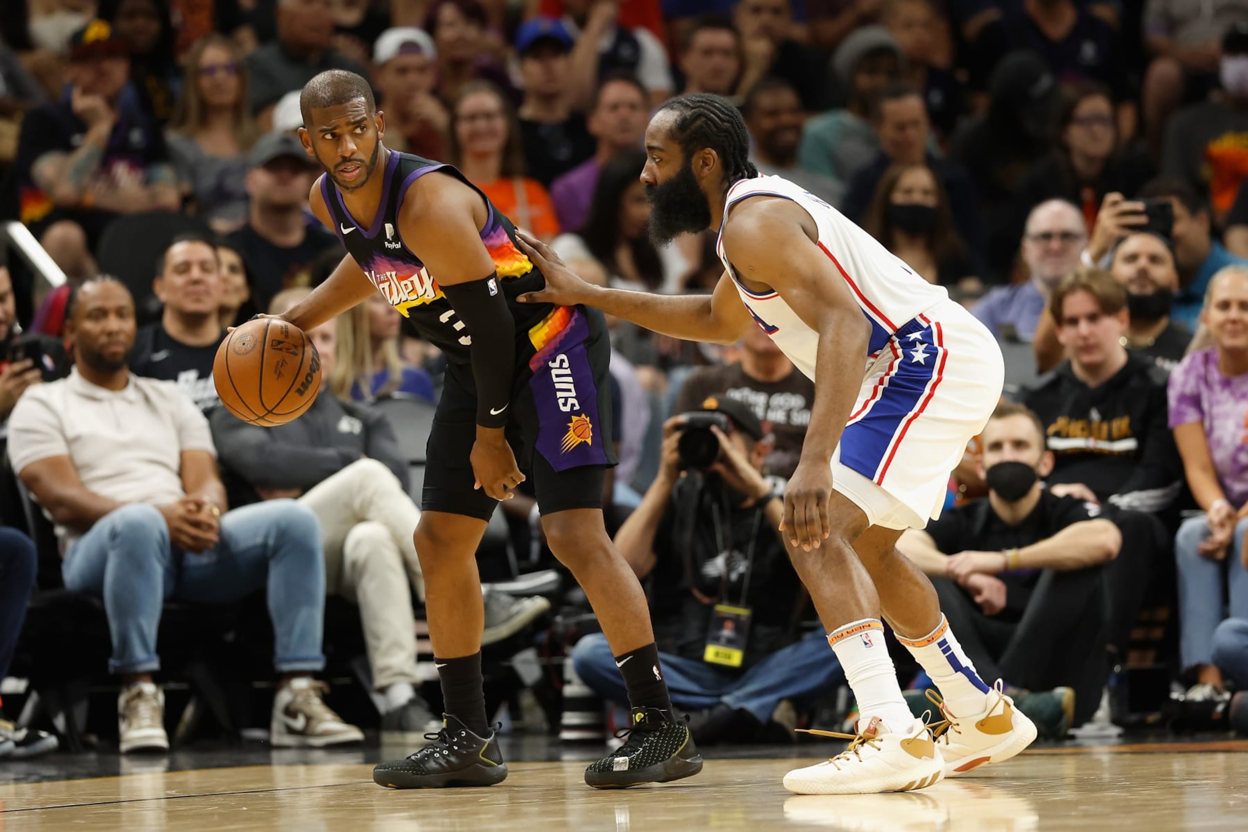 PHOENIX, ARIZONA - MARCH 27: Chris Paul #3 of the Phoenix Suns handles the ball against James Harden #1 of the Philadelphia 76ers during the first half of the NBA game at Footprint Center on March 27, 2022 in Phoenix, Arizona. NOTE TO USER: User expressly acknowledges and agrees that, by downloading and or using this photograph, User is consenting to the terms and conditions of the Getty Images License Agreement. (Photo by Christian Petersen/Getty Images)