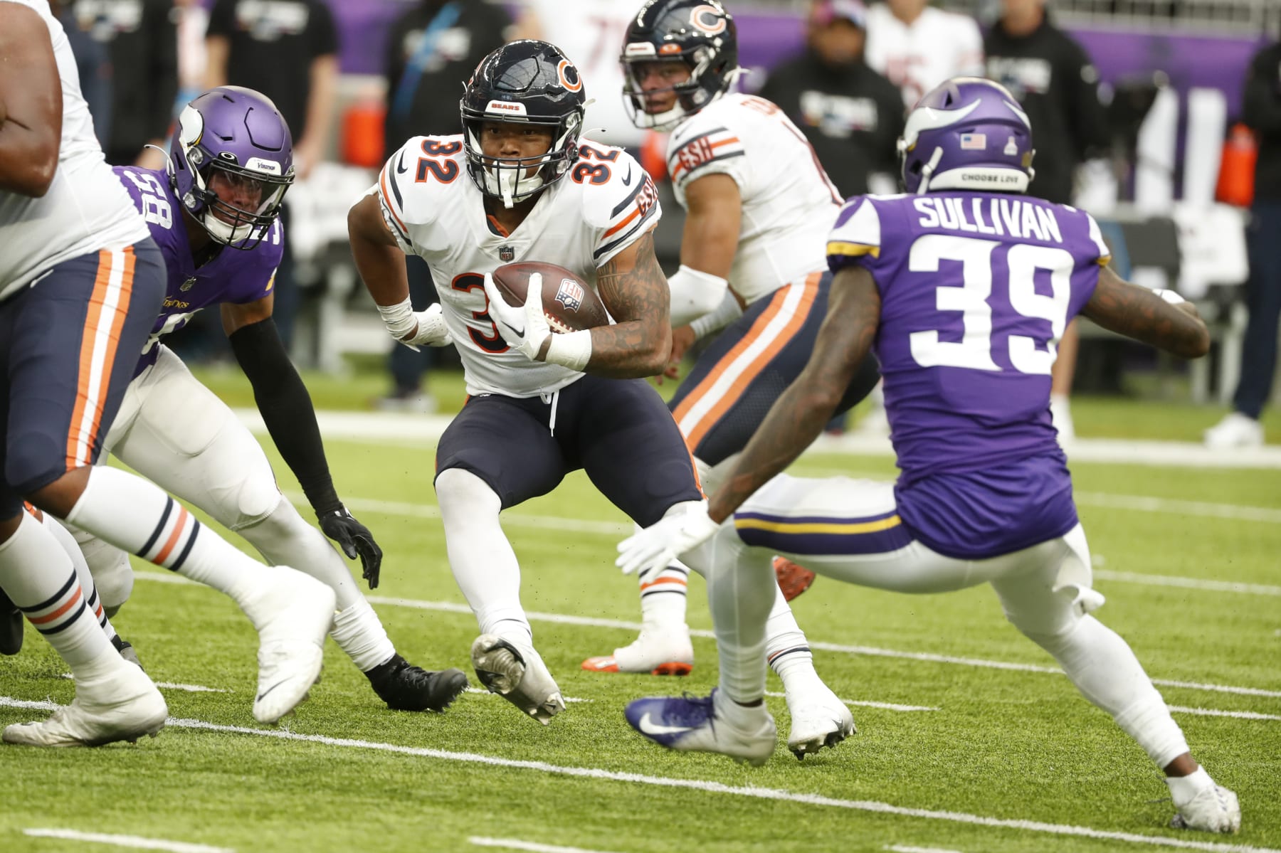 Chicago Bears running back David Montgomery (32) runs from Minnesota Vikings cornerback Chandon Sullivan (39) during the second half of an NFL football game, Sunday, Oct. 9, 2022, in Minneapolis. (AP Photo/Bruce Kluckhohn)