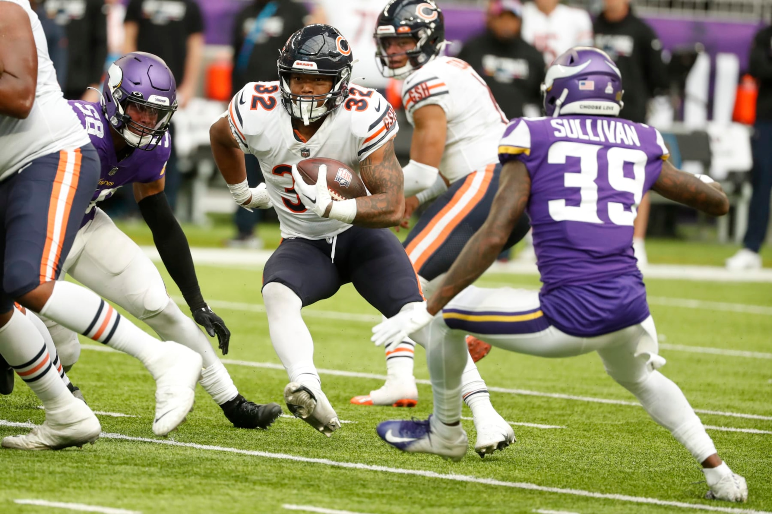 Chicago Bears running back David Montgomery (32) runs from Minnesota Vikings cornerback Chandon Sullivan (39) during the second half of an NFL football game, Sunday, Oct. 9, 2022, in Minneapolis. (AP Photo/Bruce Kluckhohn)