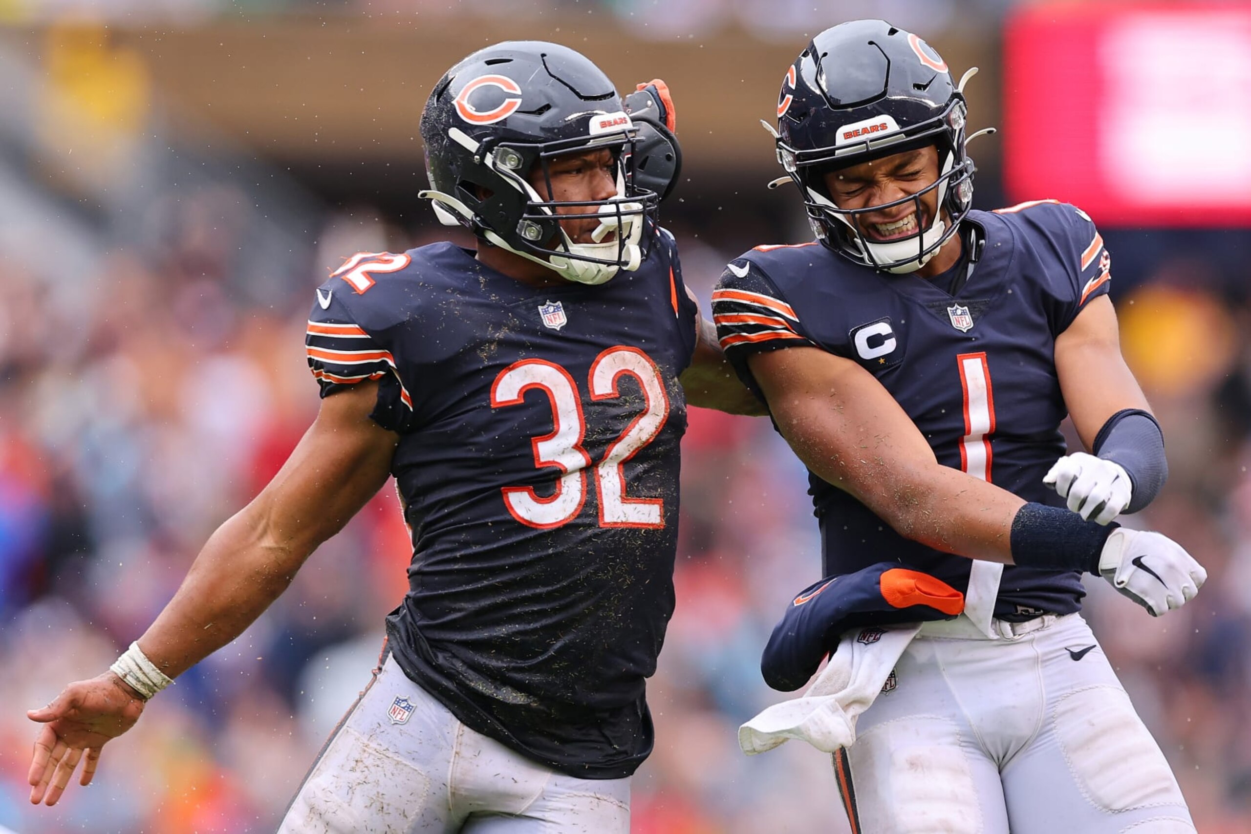 CHICAGO, ILLINOIS - SEPTEMBER 11: Running back David Montgomery #32 of the Chicago Bears celebrates with quarterback Justin Fields #1 of the Chicago Bears after Fields' touchdown pass during the fourth quarter against the San Francisco 49ers at Soldier Field on September 11, 2022 in Chicago, Illinois. (Photo by Michael Reaves/Getty Images)